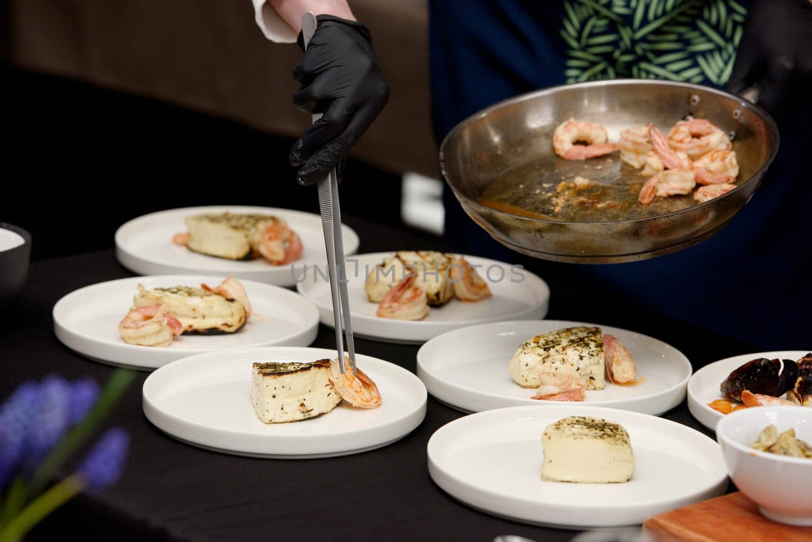 chef in the restaurant prepares saganaki, traditional Greek cheese snack that is fried in a pan or grilled by Ashtray25