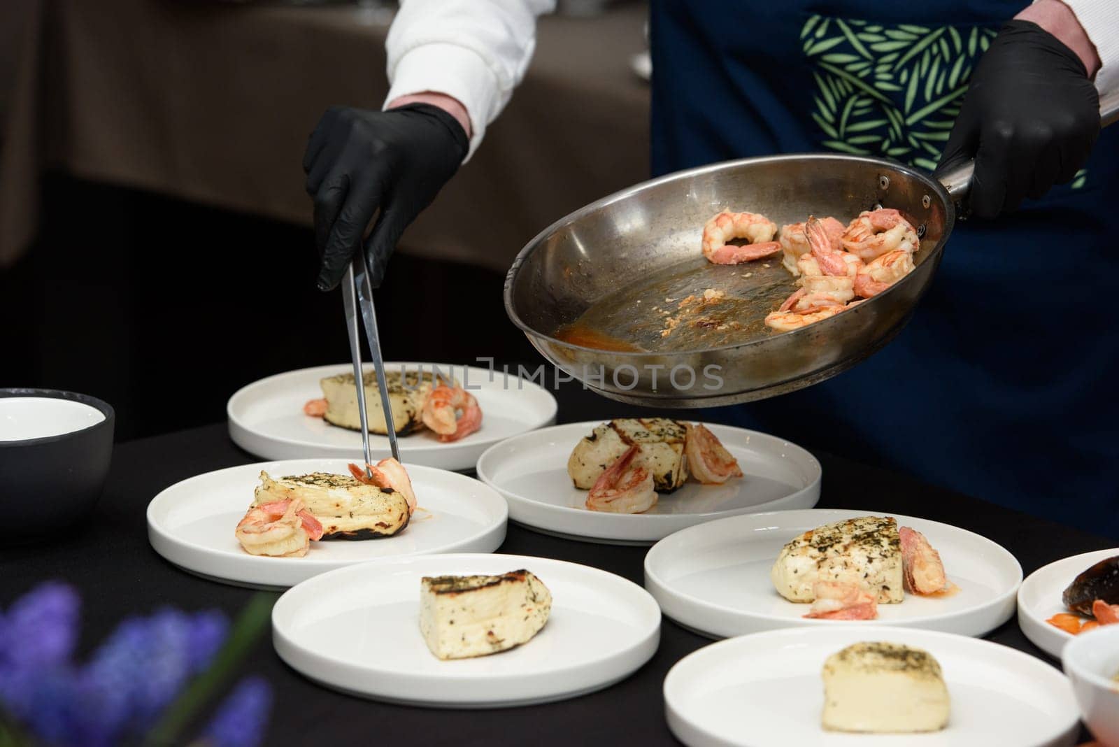 chef in the restaurant prepares saganaki, traditional Greek cheese snack that is fried in a pan or grilled by Ashtray25