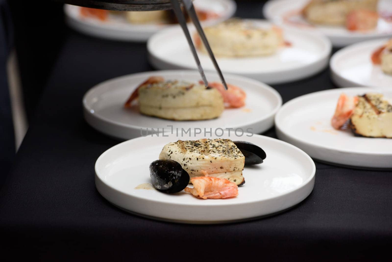 chef in the restaurant prepares saganaki, traditional Greek cheese snack that is fried in a pan or grilled by Ashtray25