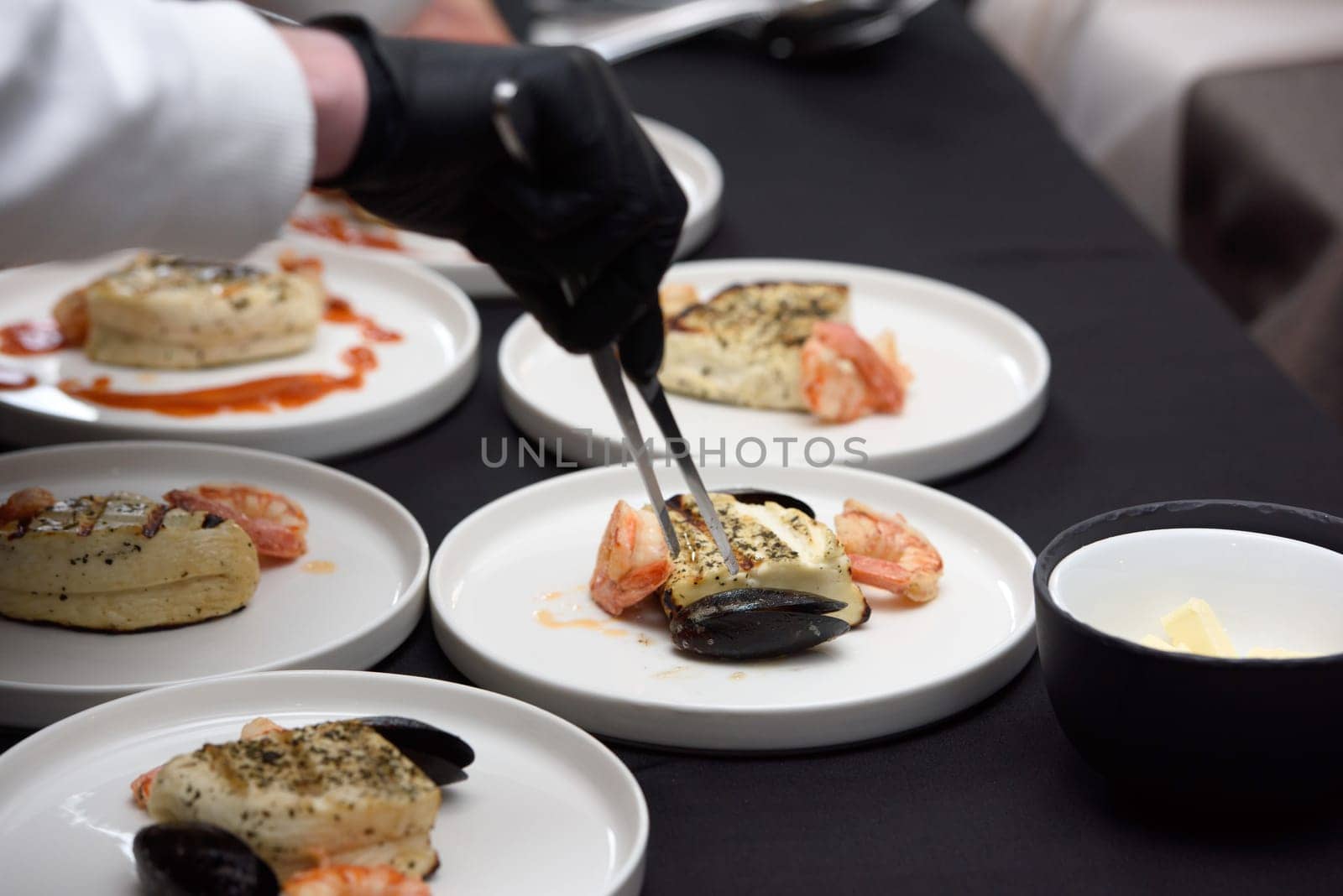 chef in the restaurant prepares saganaki, traditional Greek cheese snack that is fried in a pan or grilled by Ashtray25