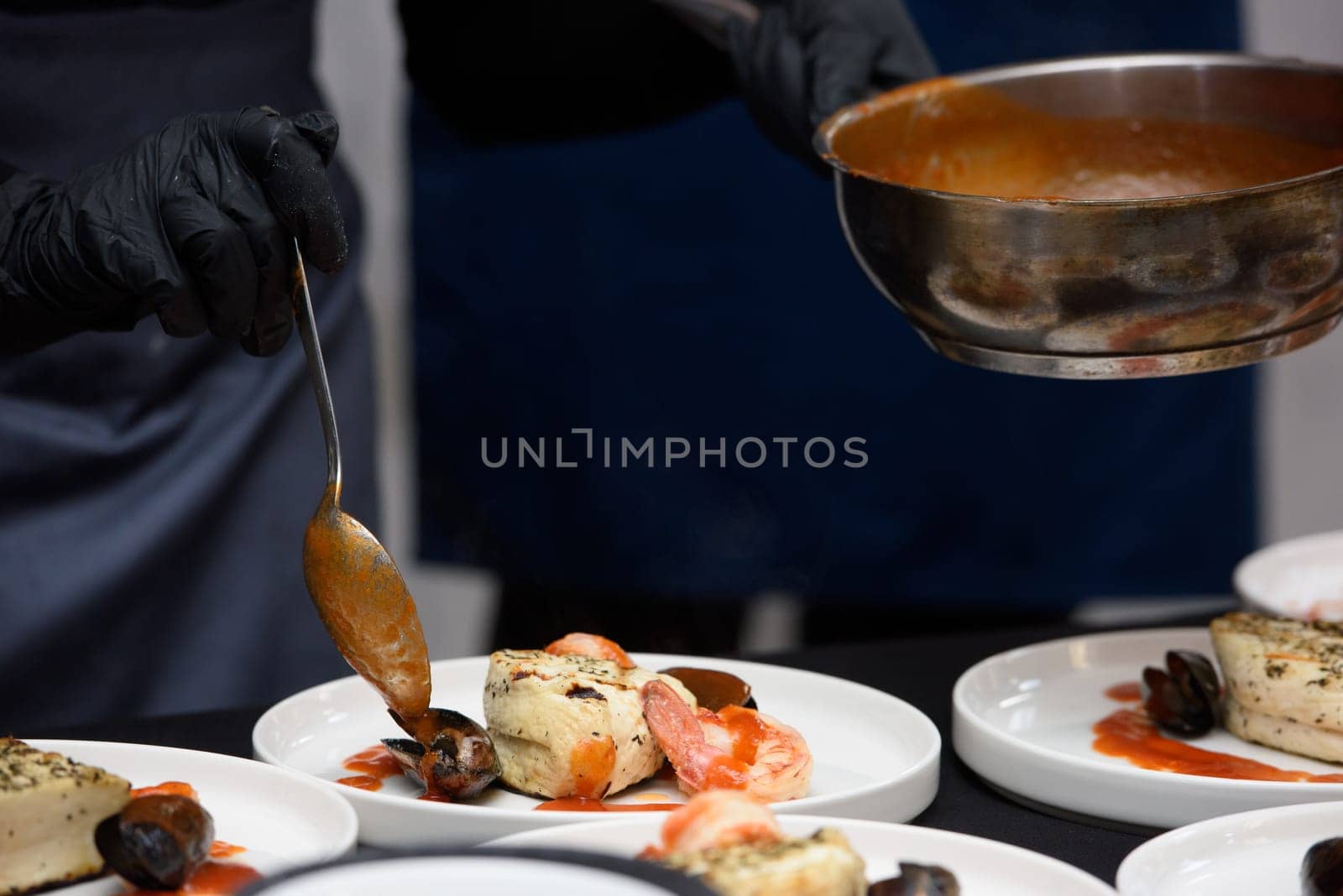 chef in the restaurant prepares saganaki, traditional Greek cheese snack that is fried in a pan or grilled by Ashtray25