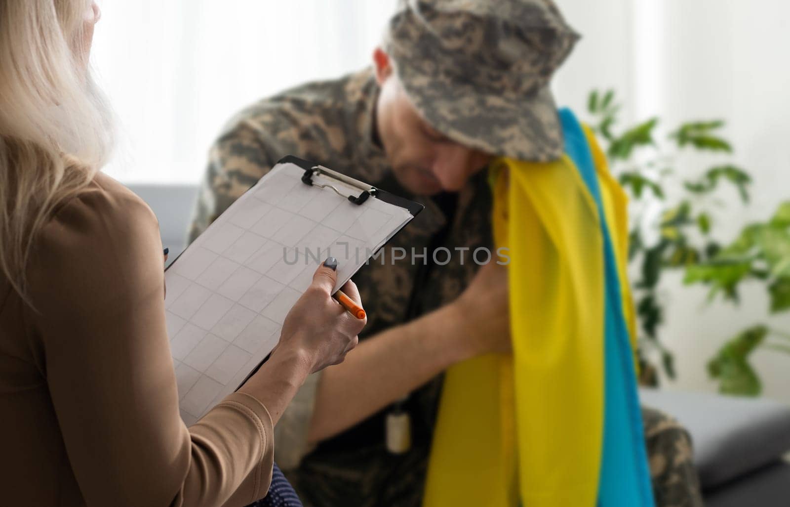Soldier military of ukraine have therapy session with psychologist indoors by Andelov13