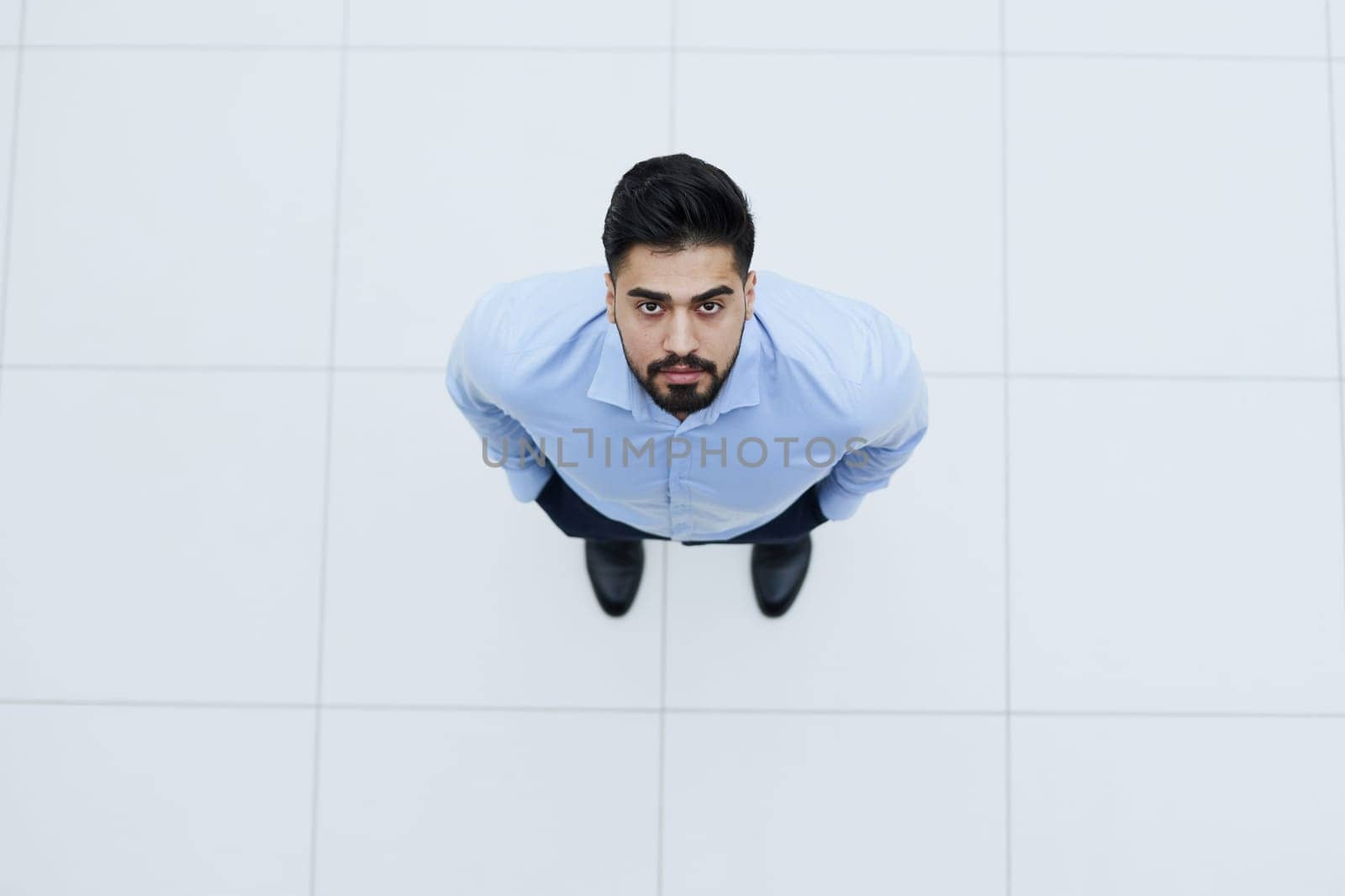 top view young businessman looking up and thinking about something