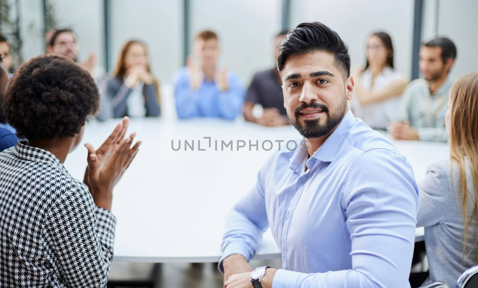 a man posing for the camera while sitting at a round table by Prosto