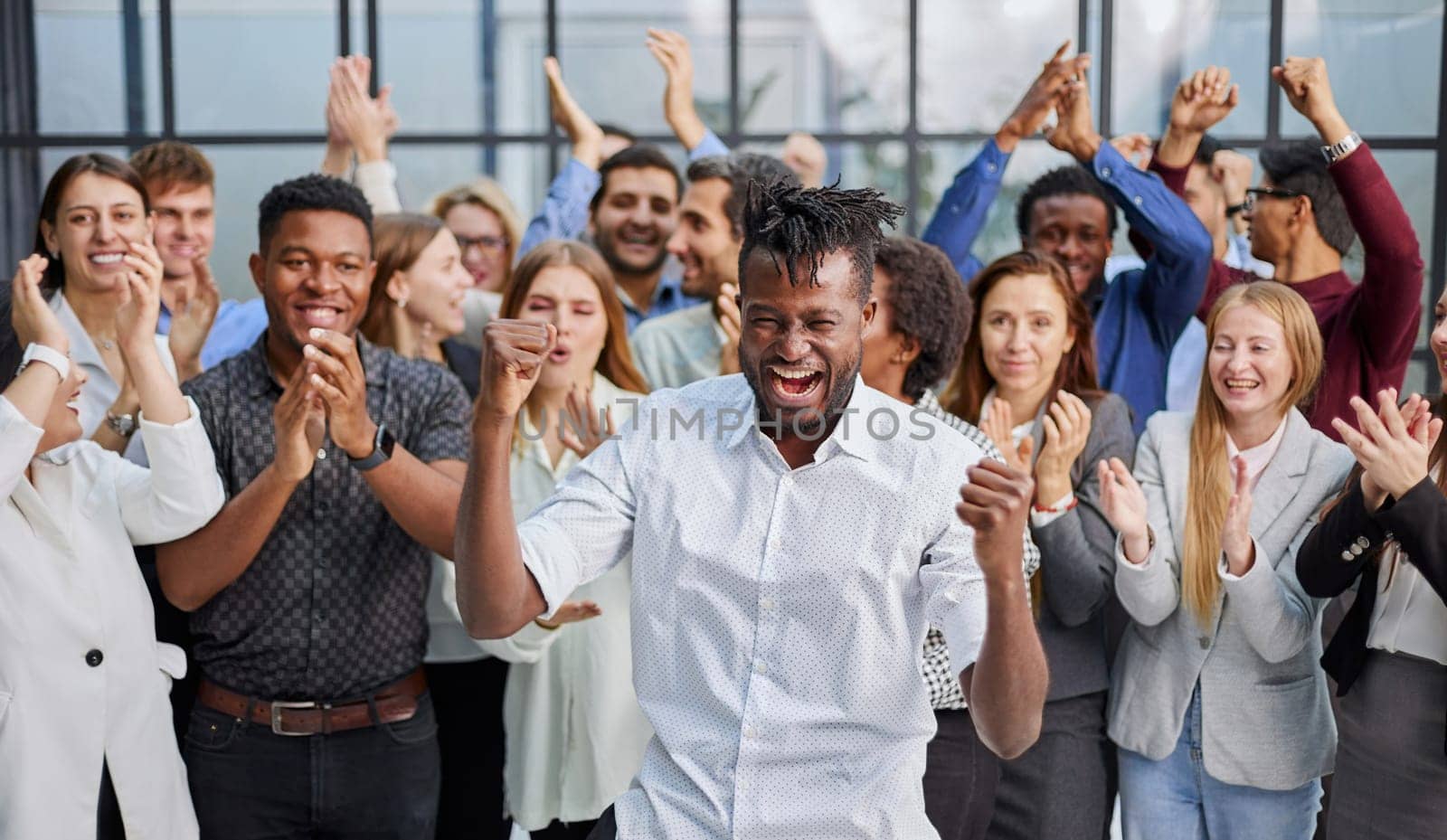 large international group of happy people applauding together standing in the lobby