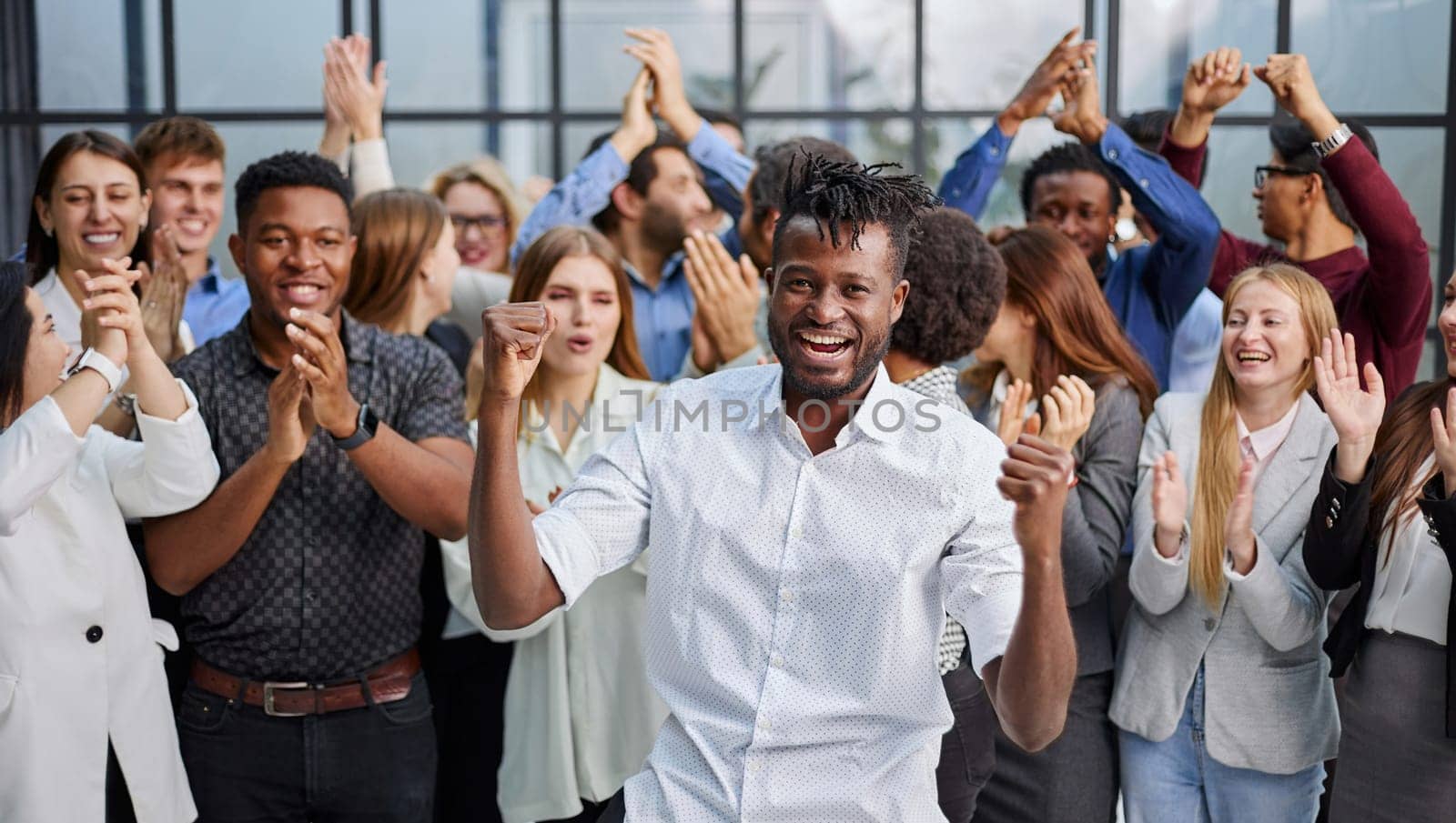 large international group of happy people applauding together standing in the lobby