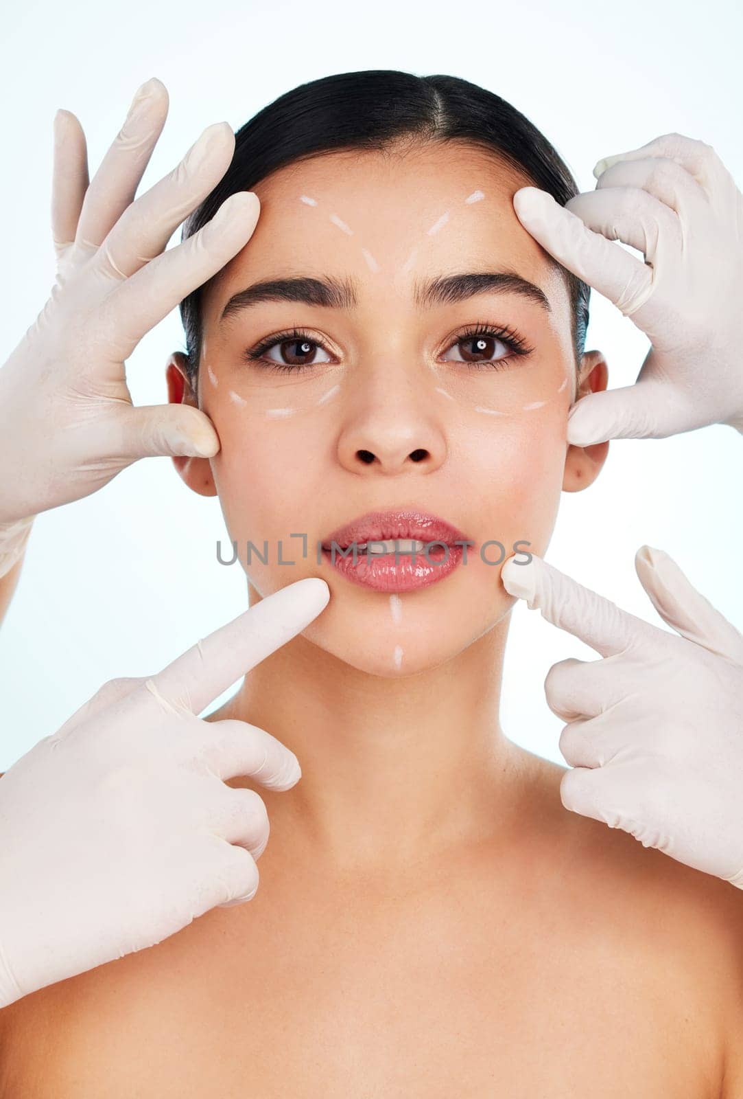 Making sure the measurements are perfect. Studio portrait of an attractive young woman having some plastic surgery done against a light background