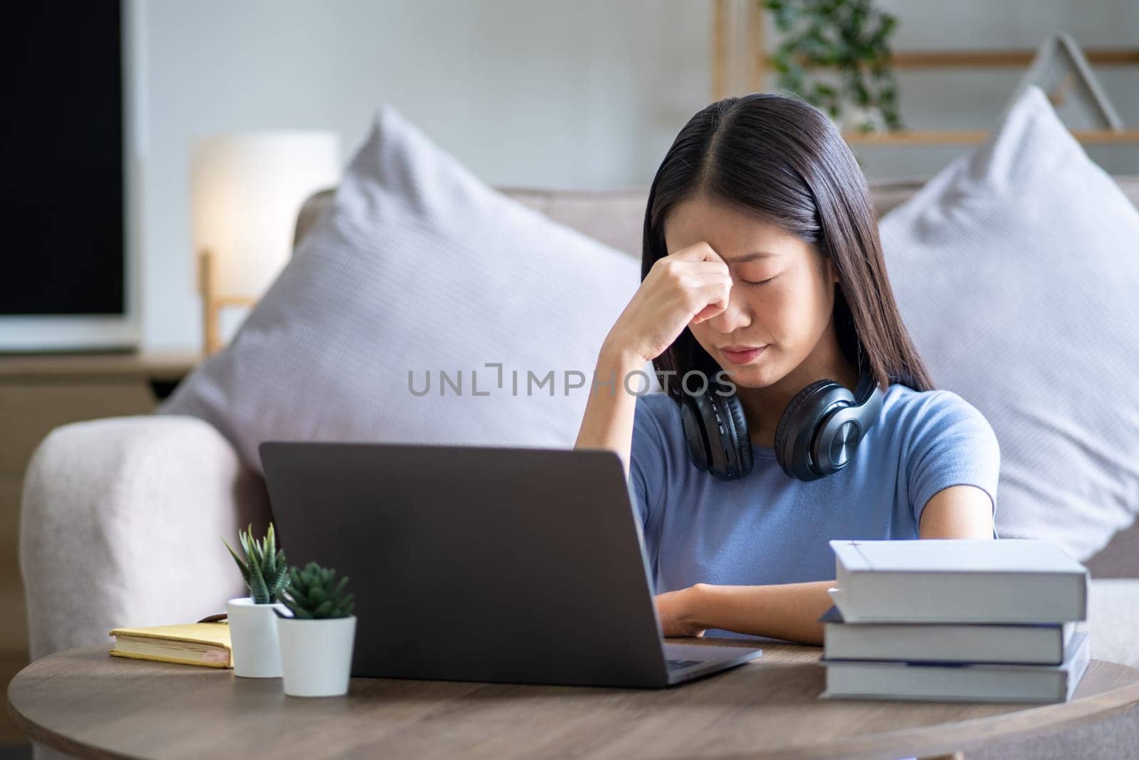 sad tired headache young Asian teenager employee touching for head, postnatal depression and stressful concern nervous serius. High quality photo