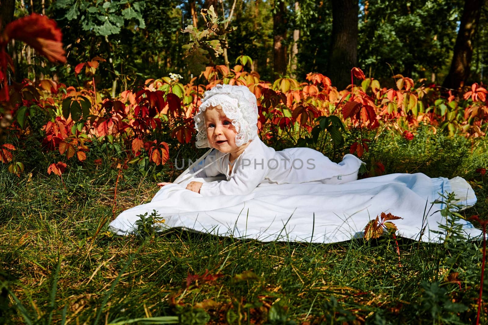 Cute baby explores the world in a sunny forest colorful summer meadow. by jovani68