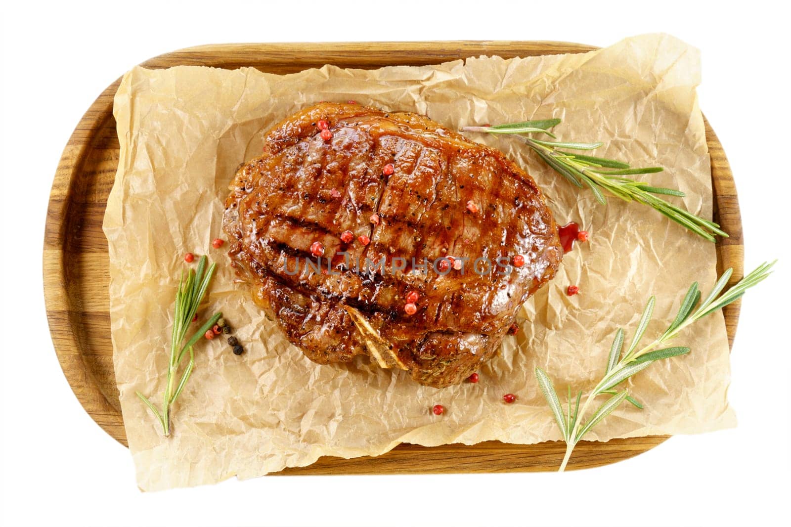 Fried ready-made steak close-up, delicious, restaurant. Seasoned with pepper, peas and herbs. Isolated on a white background