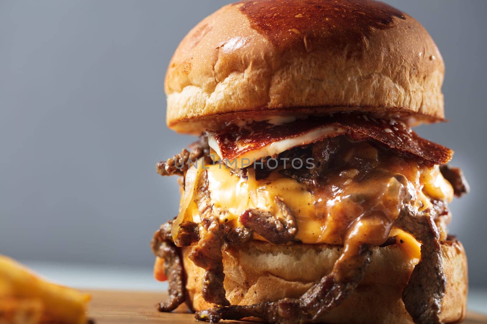 Double steak burger with smoked bacon, cheddar cheese and bbq sauce. High quality photo
