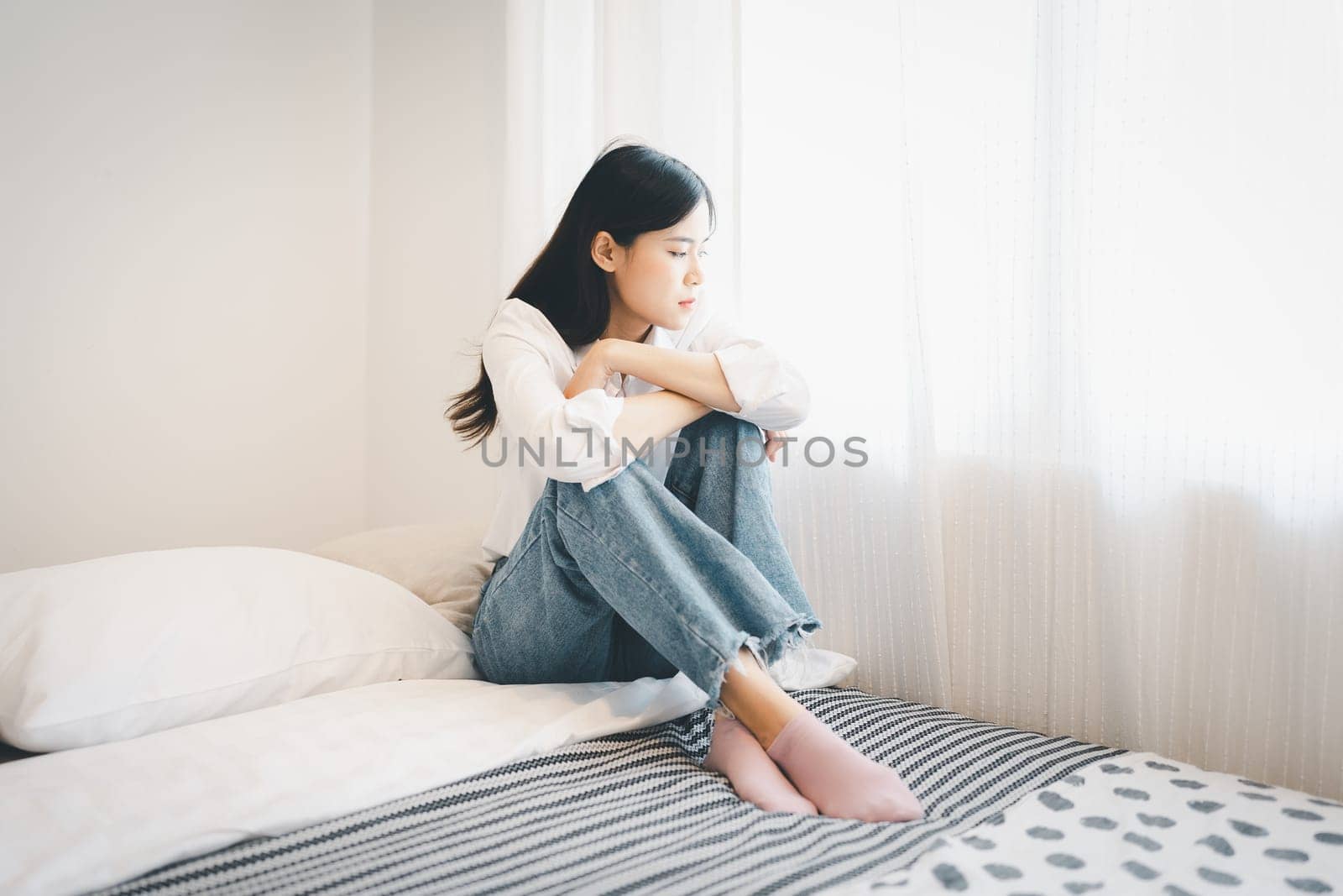 Young attractive asian woman lying at home living room couch feeling sad tired and worried suffering depression in mental health, problems and broken heart concept