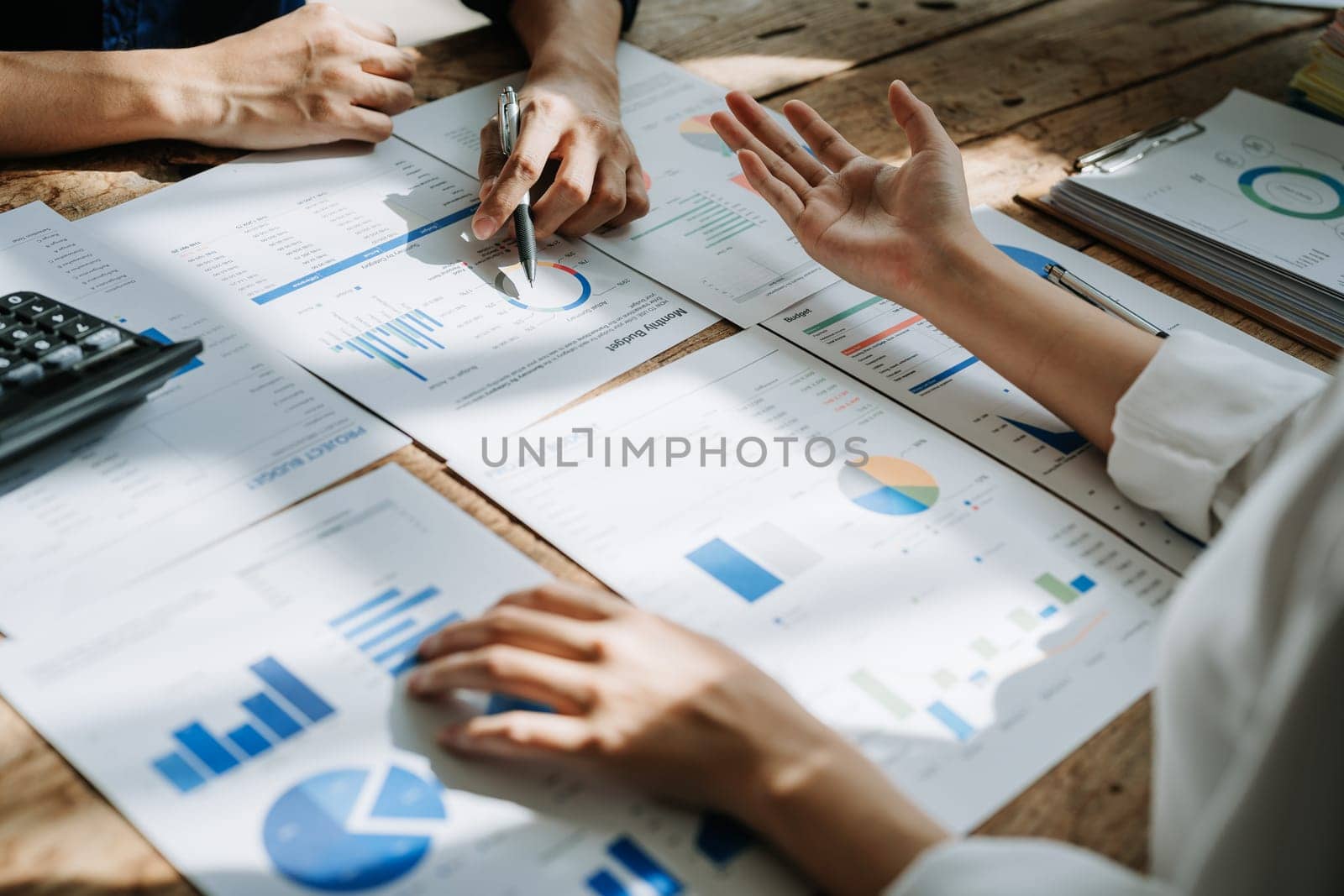 startup business, business advisor explaining strategy for planning finance investment teamwork paperwork audit and discussing marketing, profit, budget of company in meeting room. by Manastrong