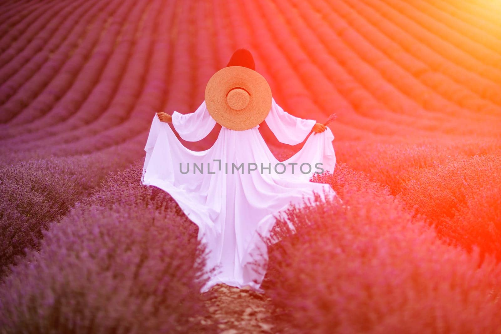 Woman lavender field. Lavender field happy woman in white dress in lavender field summer time at sunset by Matiunina