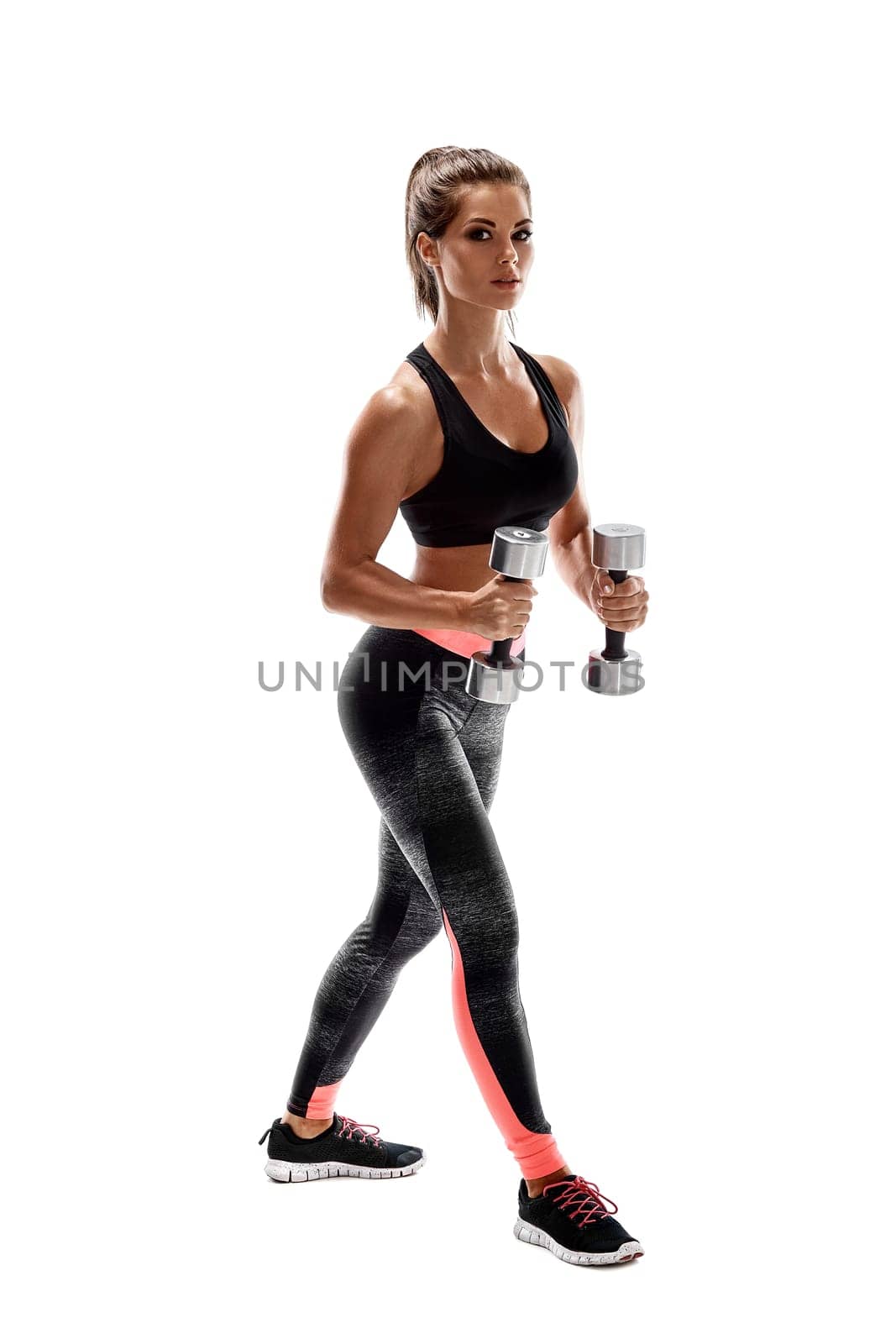 Strong woman exercising with dumbbells for arms. Photo of woman working out with dumbbells on white background. Strength and motivation.