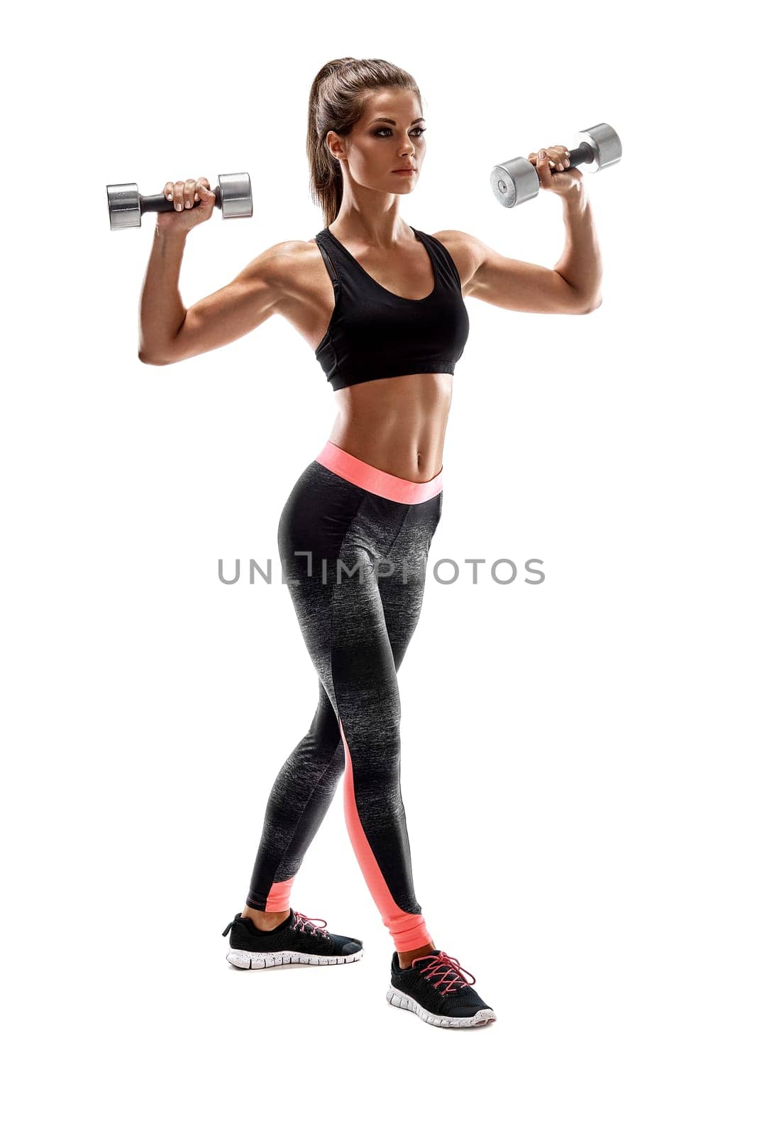 Strong woman exercising with dumbbells for arms. Photo of woman working out with dumbbells on white background. Strength and motivation.