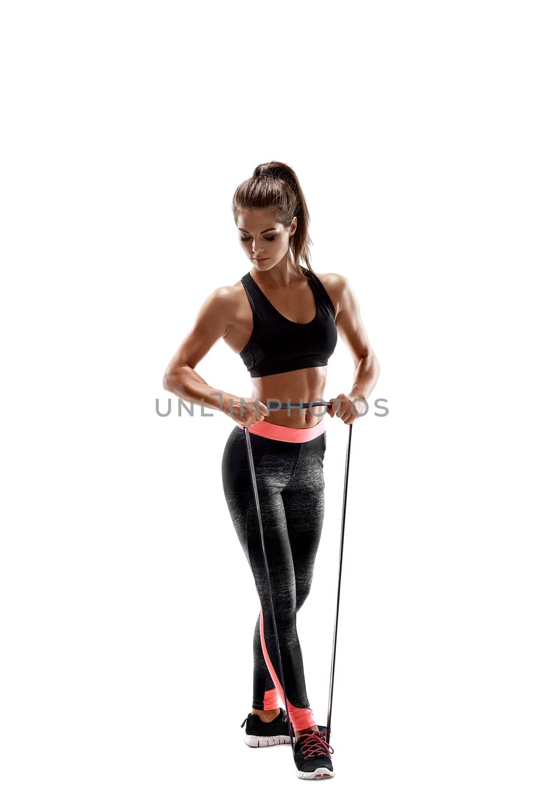 One caucasian woman exercising fitness resistance bands in studio silhouette isolated on white background