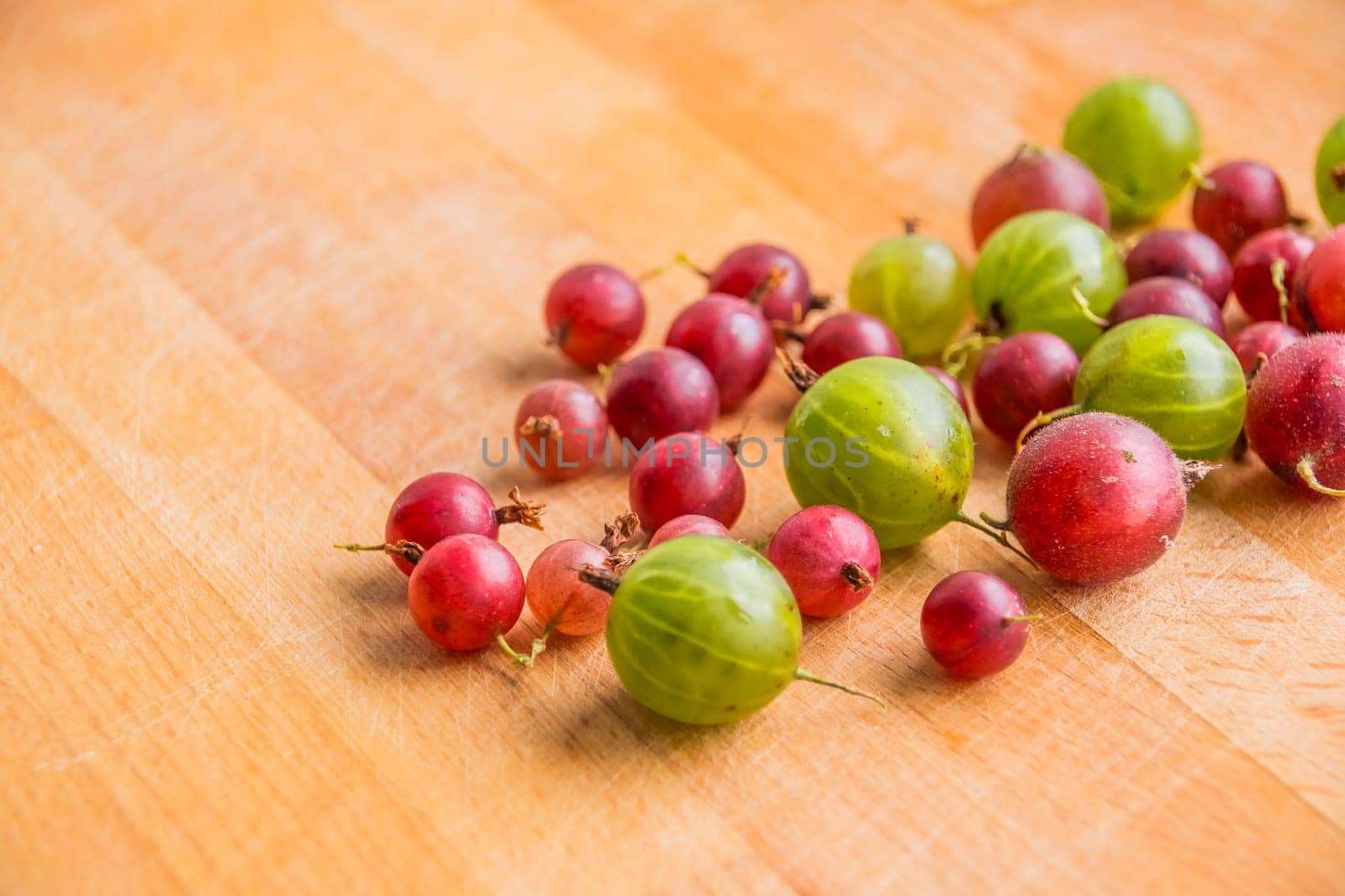 red green gooseberry on white