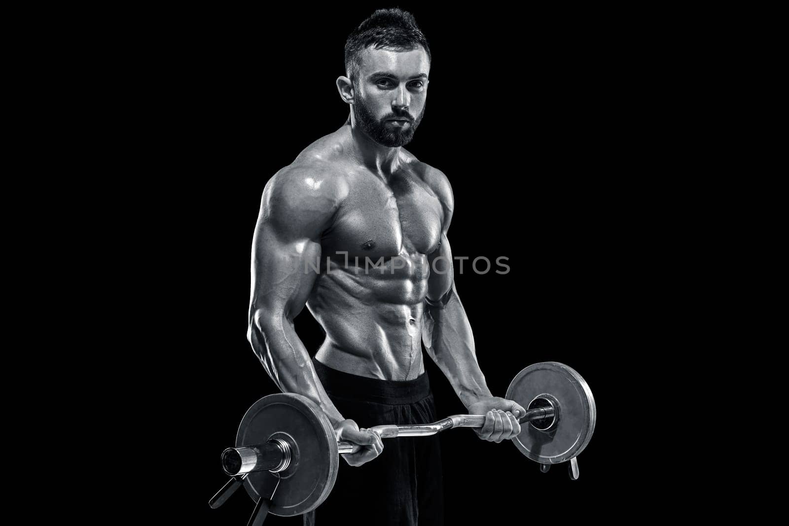 muscular man lifting weights over dark background by nazarovsergey