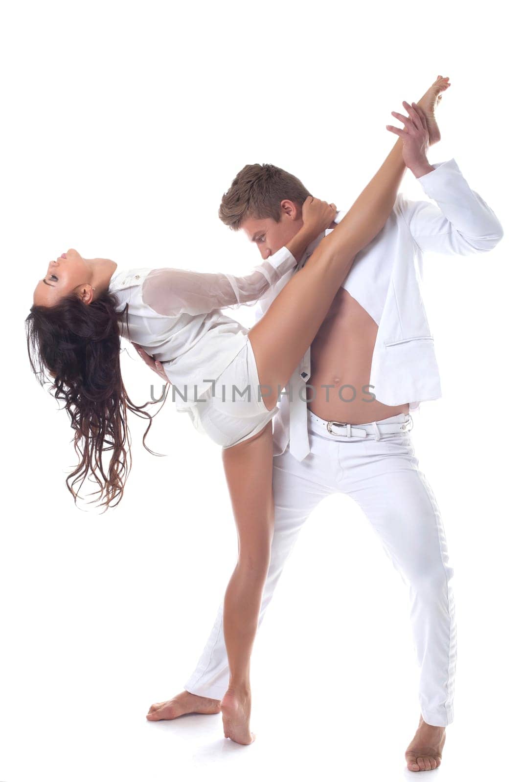 Attractive passionate dancers posing in studio, isolated on white