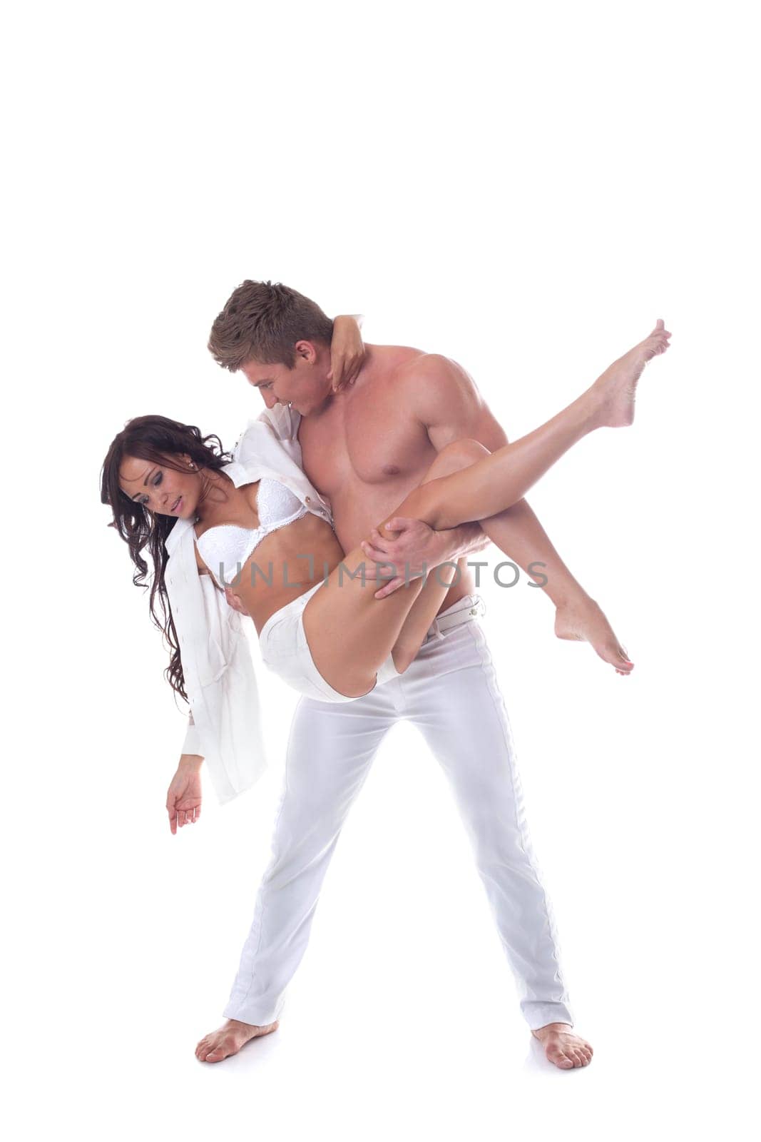 Handsome muscular man carries pretty partner, isolated on white