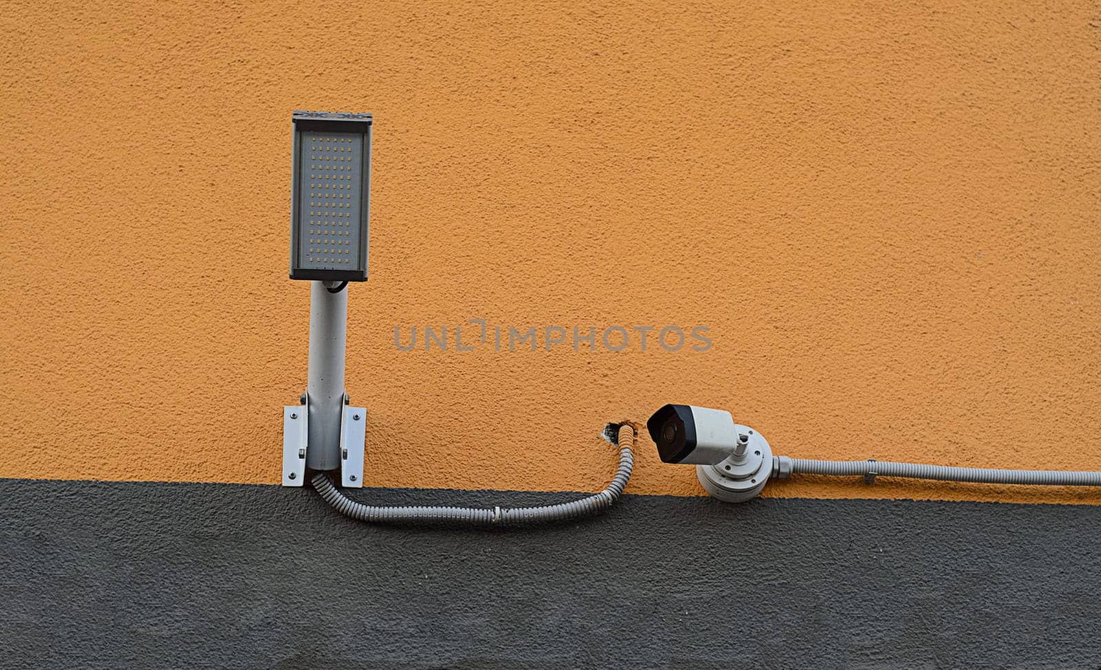 camera for security with lamp on house wall.