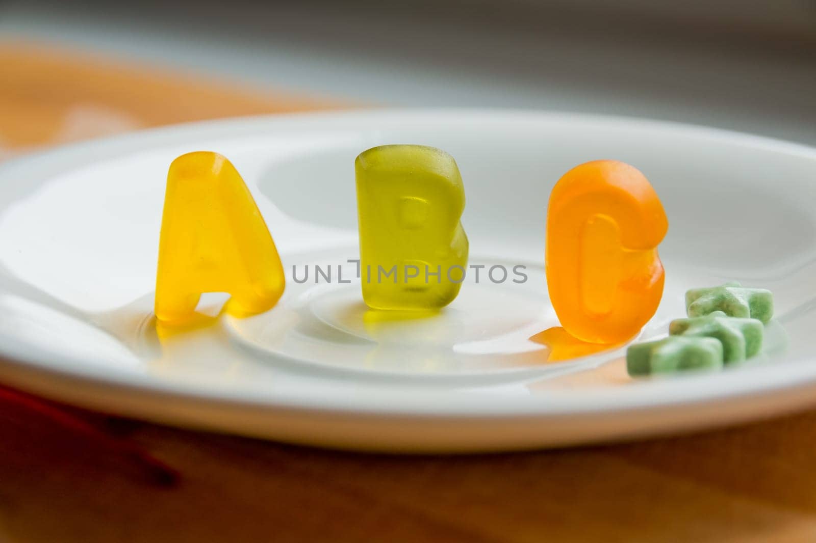 Jelly bean sweets and ABC letters. Education and alphabet concept