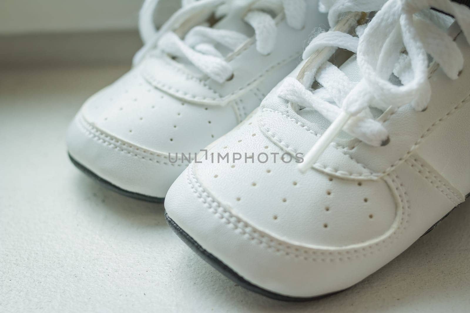 pair of white sport sneaker shoes on black reflective background