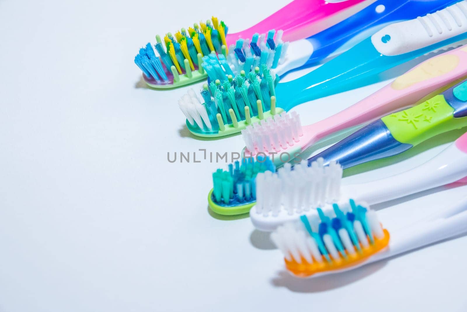 whitening. tooth care. teeth healthy concept. New ultra soft toothbrushes in a row, Dental Industry. various types of toothbrushes. beautiful smile concept. by YuliaYaspe1979