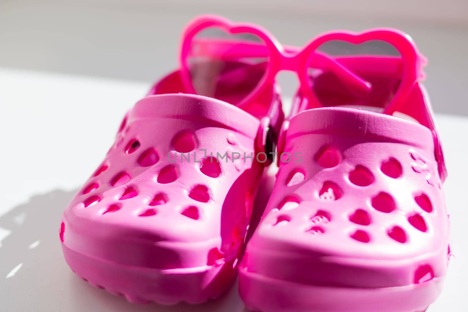 Pink rubber slippers, isolated on white background. Children's rubber sandals isolated