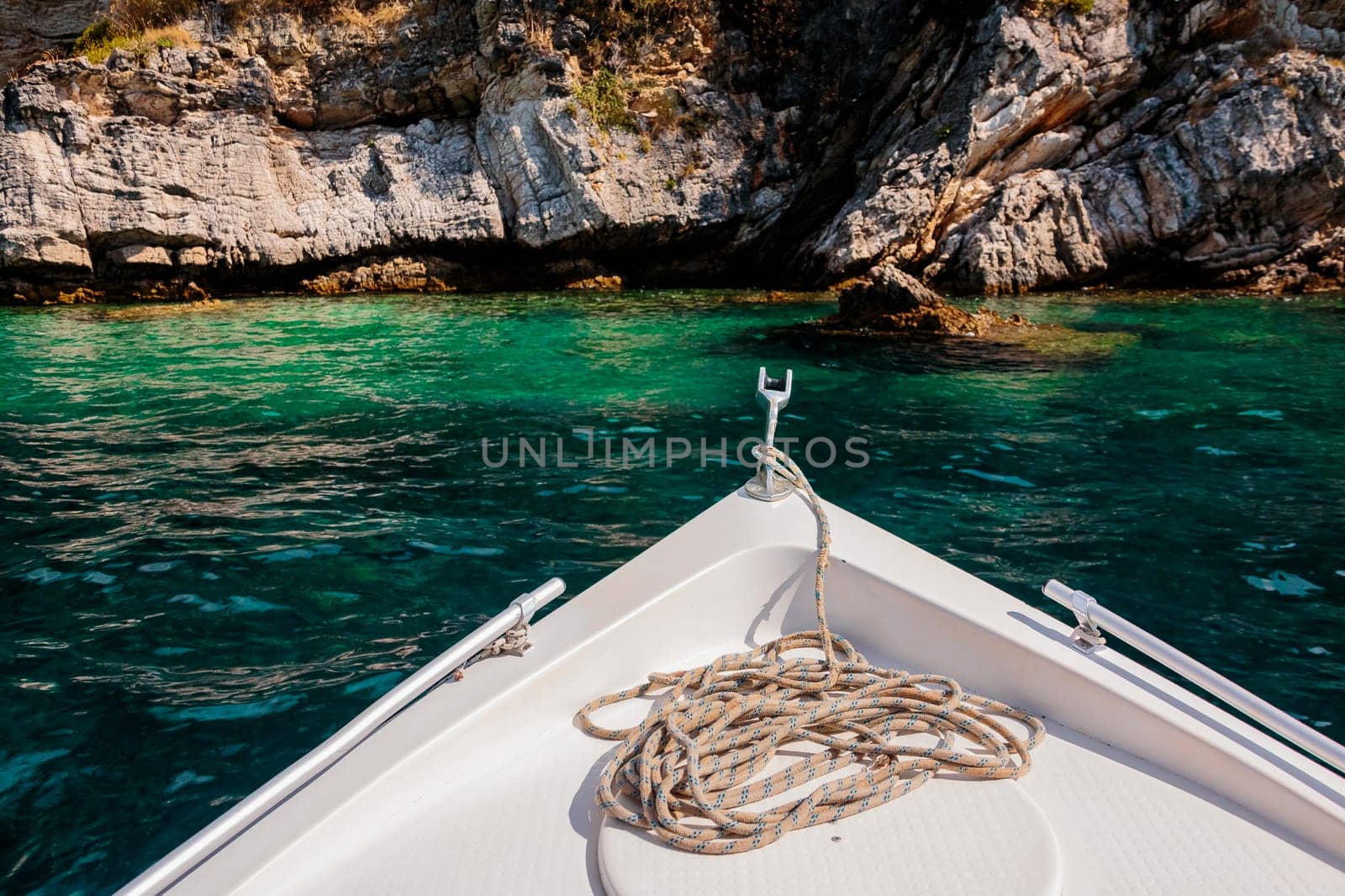 Summer time view from yacht gangway on the small beach of Love bay Poros island Greece.