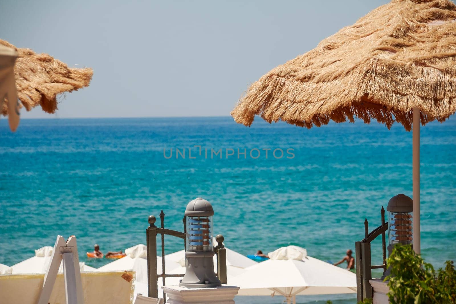Summer Seaside Restaurant Terrace or Veranda Interior, Flattering Curtains, Metal Lanterns, White Wooden Furniture, Sea View.