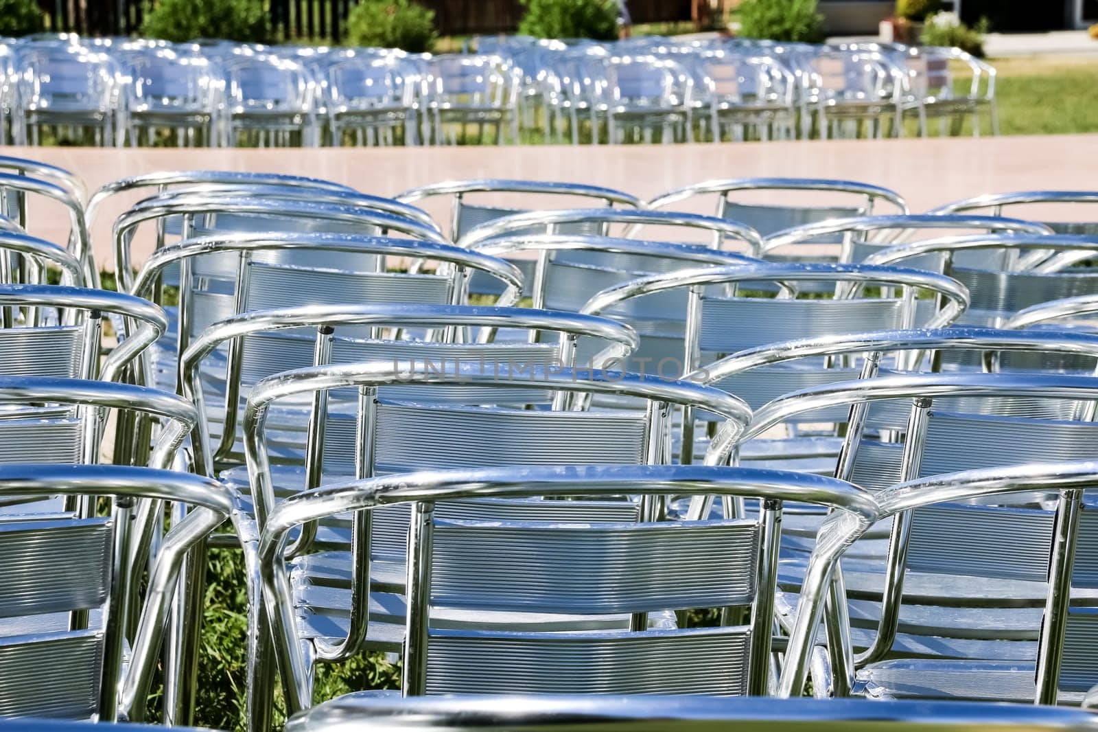 Rows of empty metal chair seats installed for some business event or performance,festival