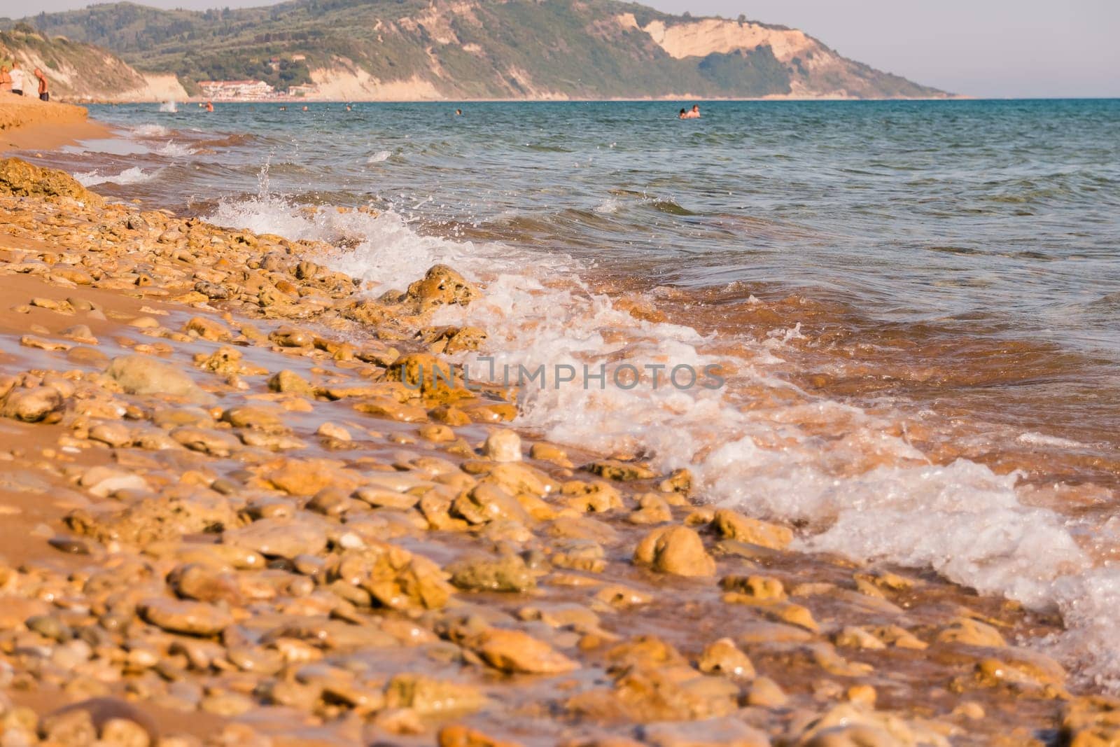 View to the shore with stones sand in Europe.landscape coastline with stones on sunny day
