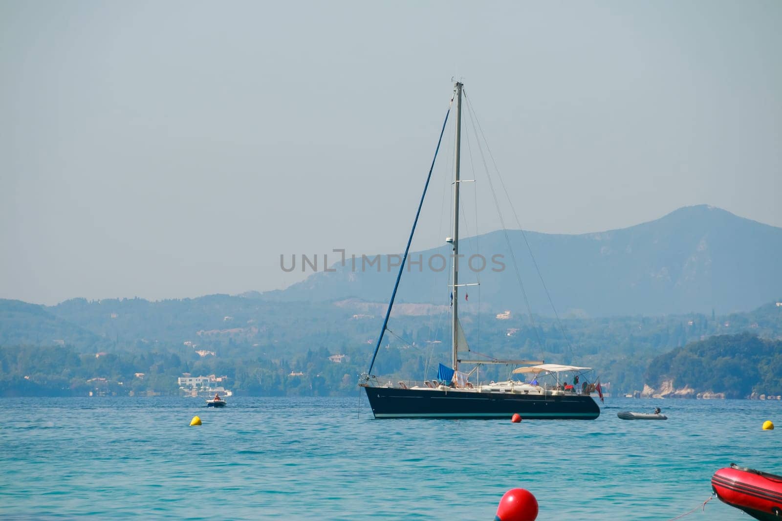 Seascape with sailboat the background of the blue sky.
