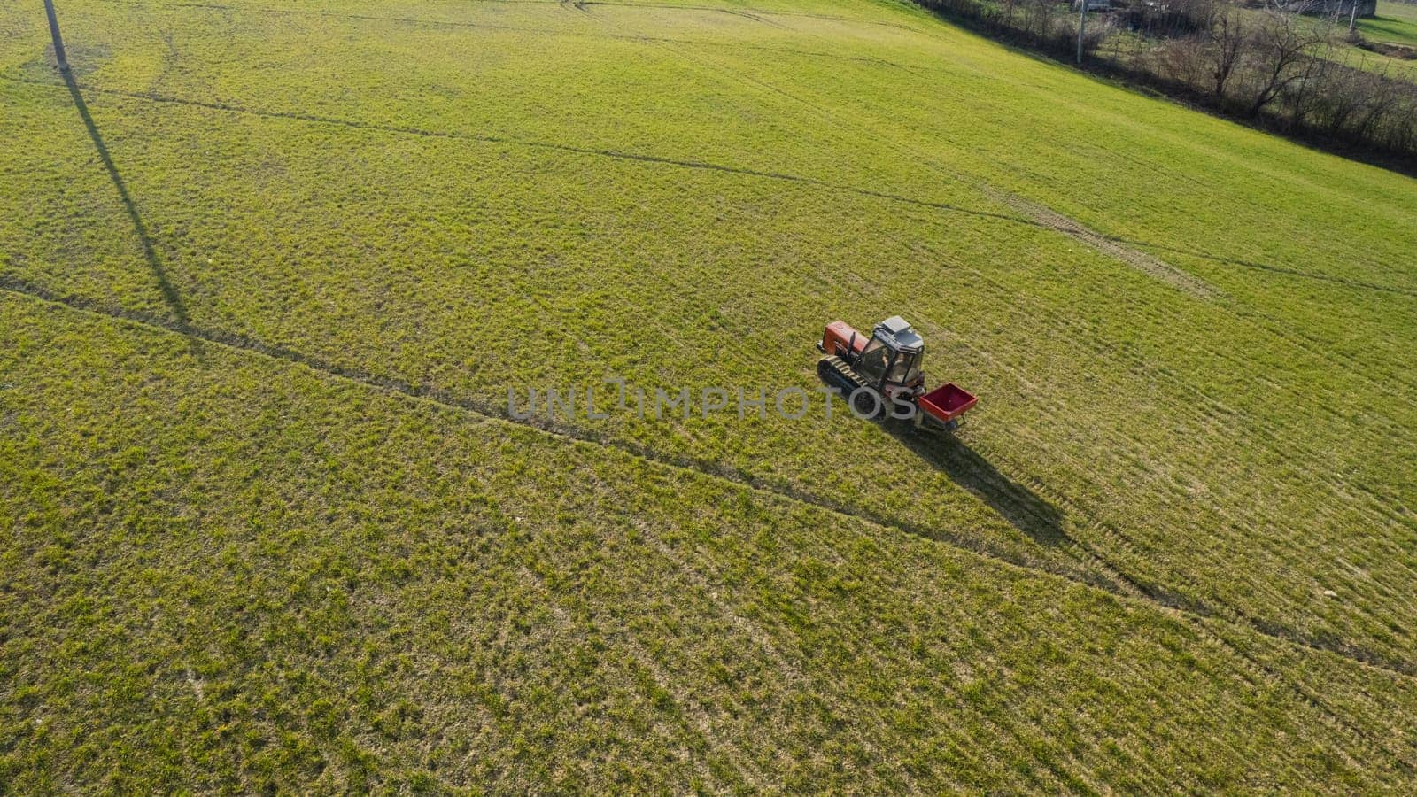 farmer driving uphill crawled tractor in the farm during spring season