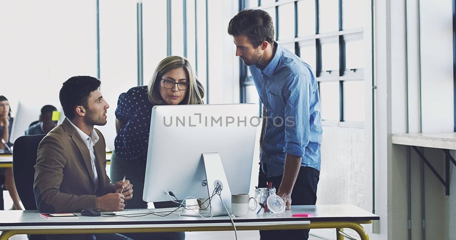 Collaboration, management and team working together on a web design at a startup company office using internet. Group, teamwork and business people using computer for developers of idea.