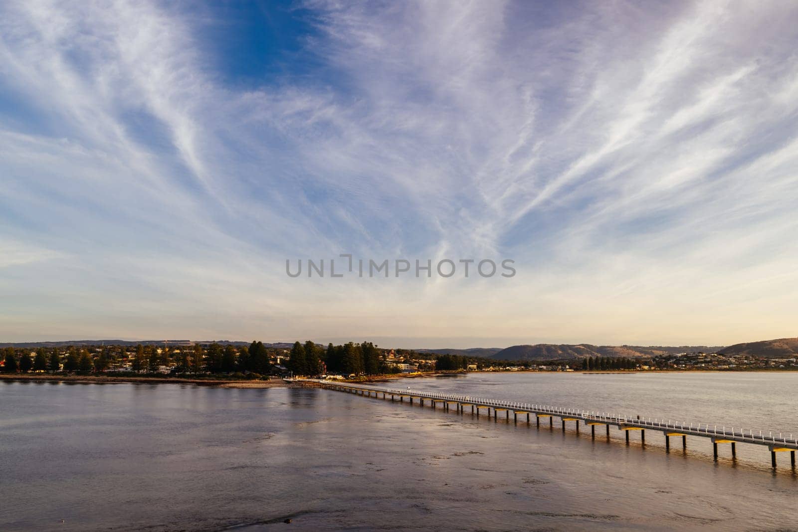 A view of the famous causeway leading to Granite Island Recreation Park at sunrise in Victor Harbor on a sunny autumn day in South Australia, Australia