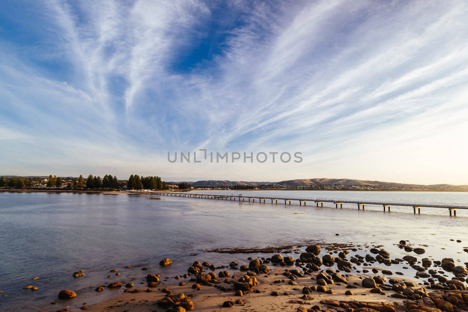 A view of the famous causeway leading to Granite Island Recreation Park at sunrise in Victor Harbor on a sunny autumn day in South Australia, Australia