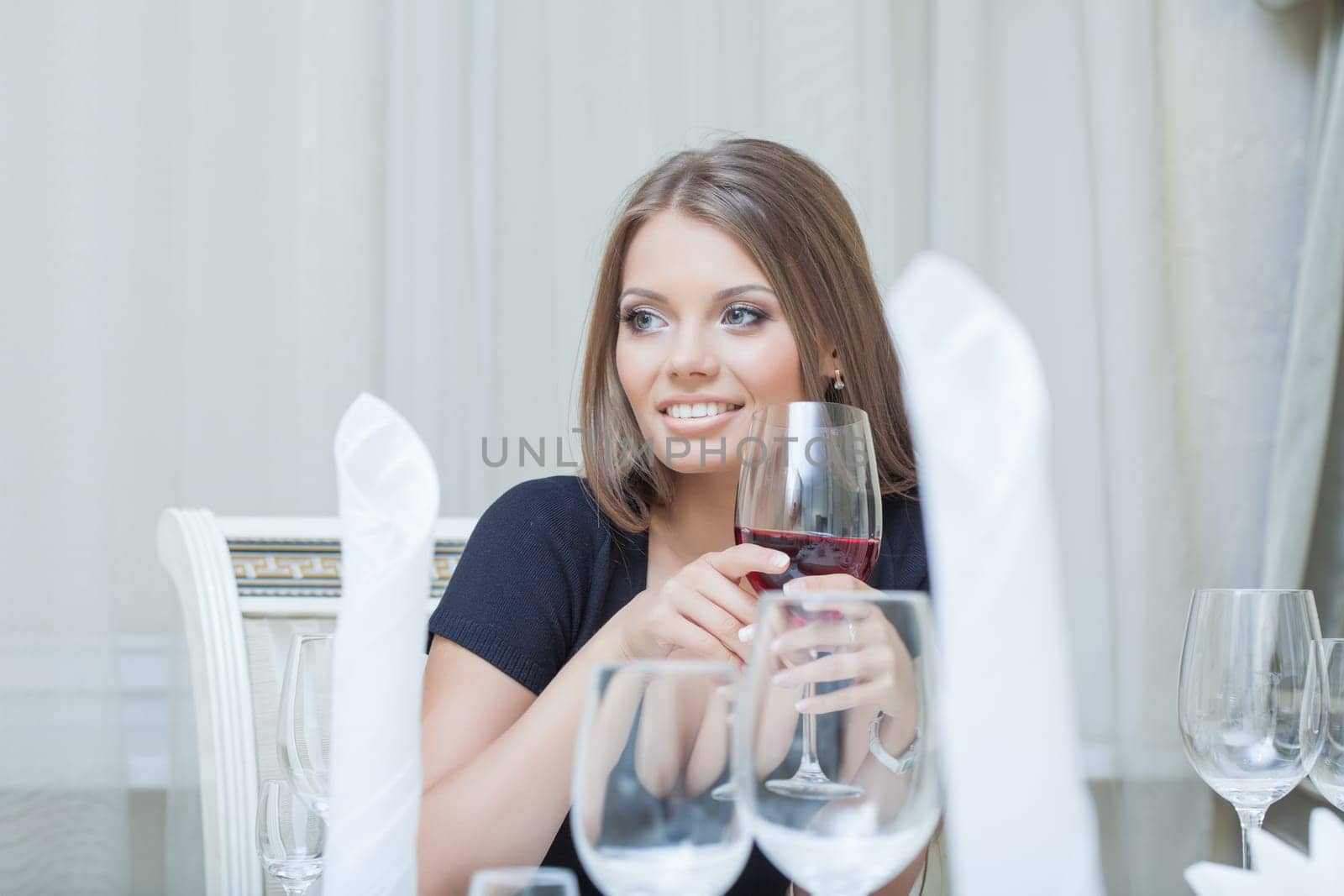 Portrait of beautiful young woman smiling in restaurant