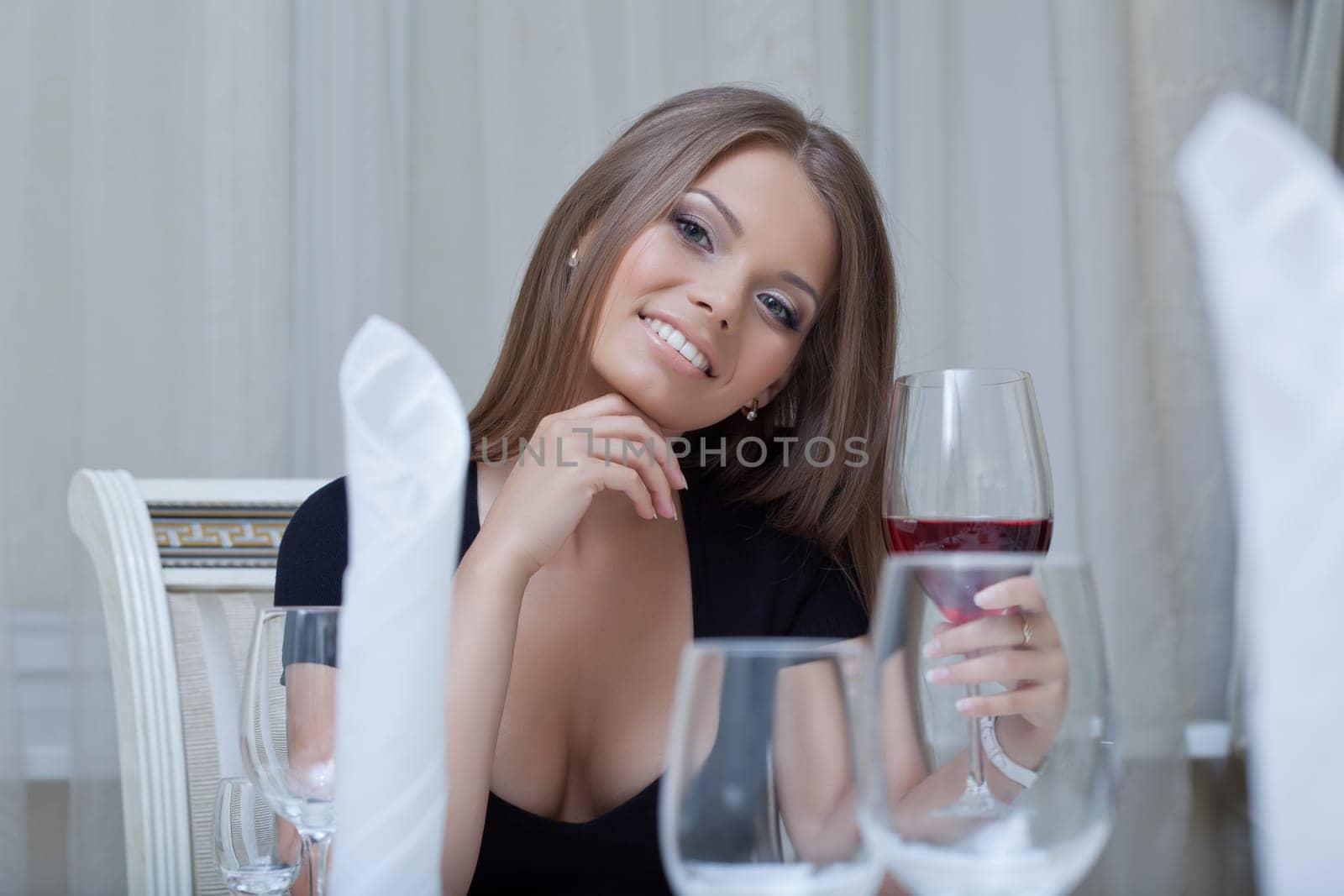 Image of seductive slender woman smiling at camera, close-up