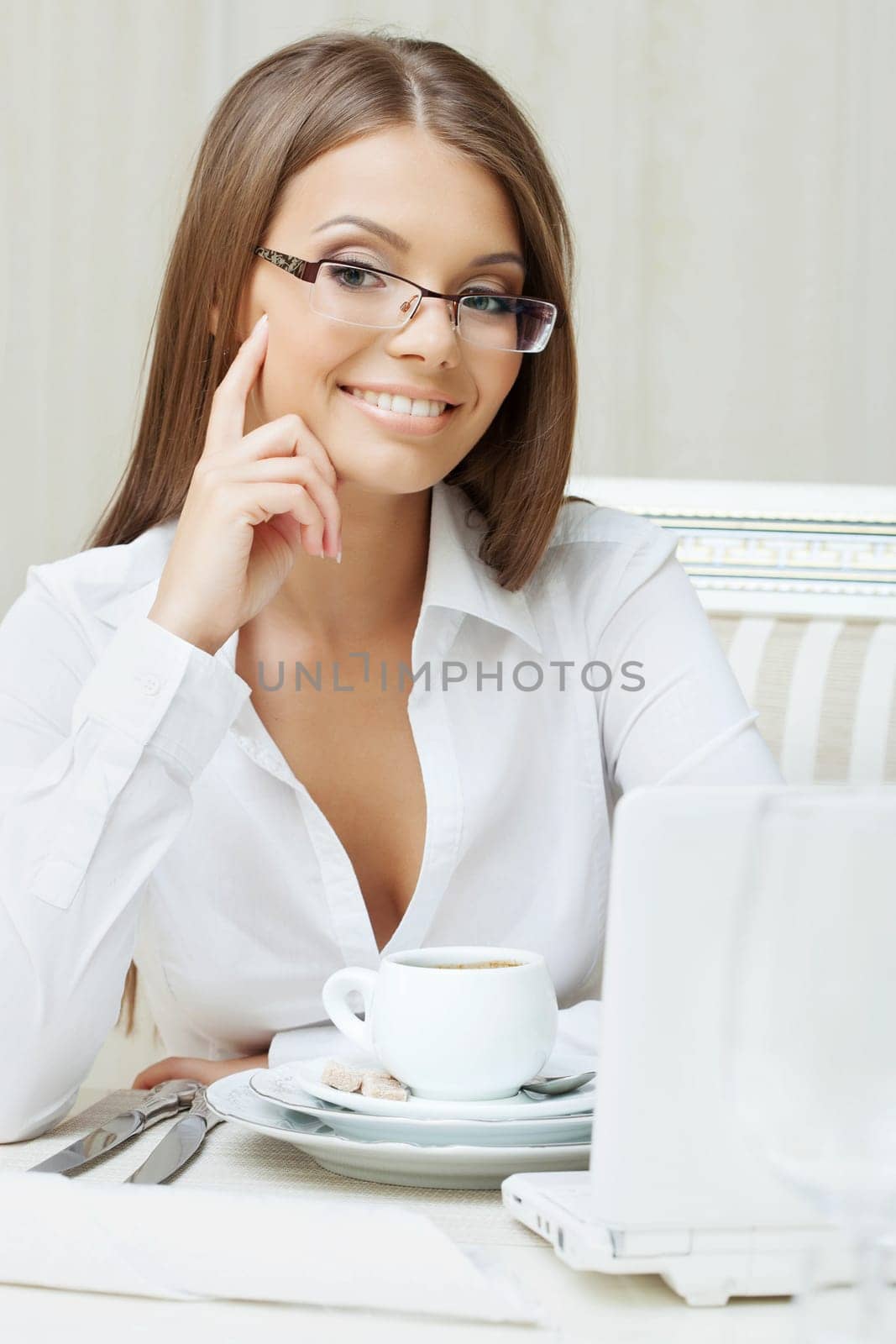 Smiling business woman sitting at table in restaurant, close-up