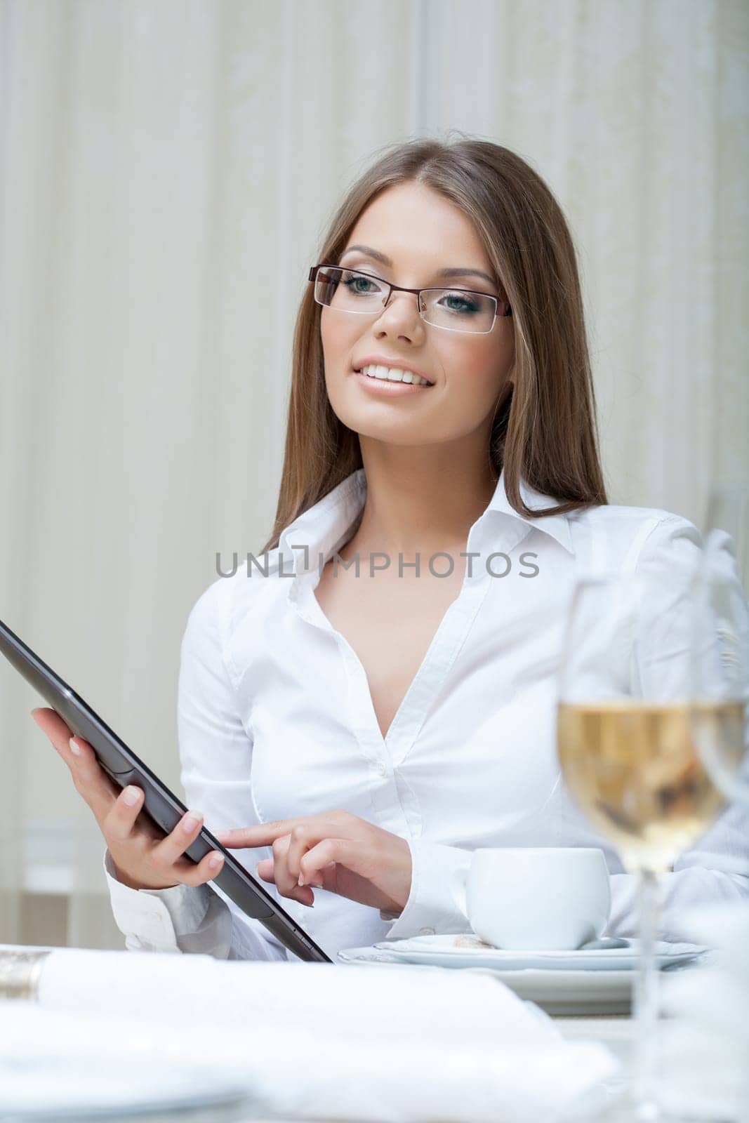 Smiling business woman working on PC tablet, close-up