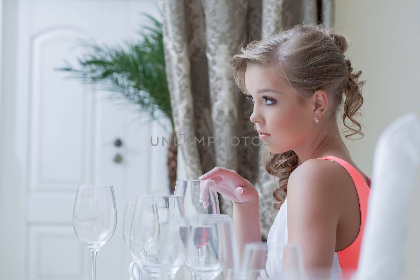 Image of young cute girl posing with wine glasses, close-up