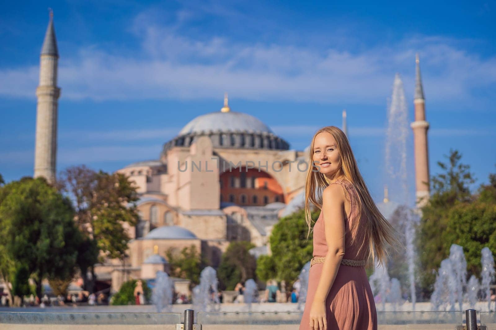 Woman enjoy beautiful view on Hagia Sophia Cathedral, famous islamic Landmark mosque, Travel to Istanbul, Turkey. Sunny day architecture and Hagia Sophia Museum, in Eminonu, istanbul, Turkey. Turkiye by galitskaya
