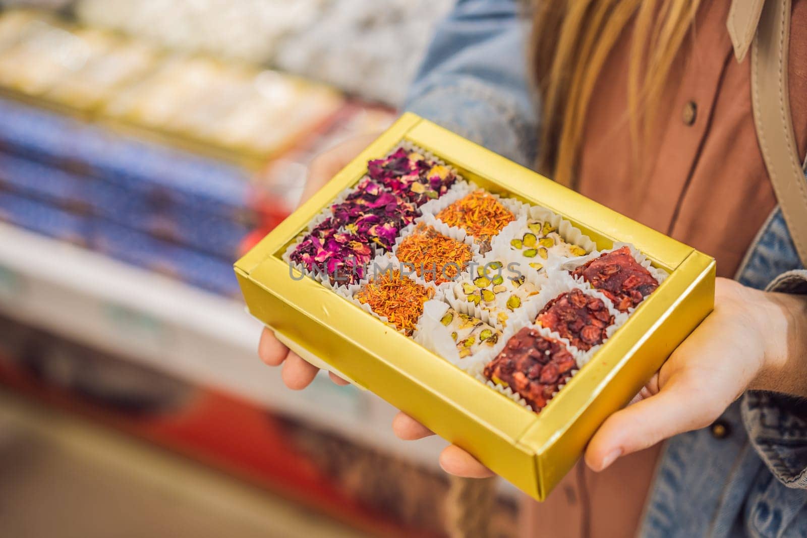 Traditional oriental sweet pastry cookies, nuts, dried fruits, pastilles, marmalade, Turkish desert with sugar, honey and pistachio, in display at a street food market.