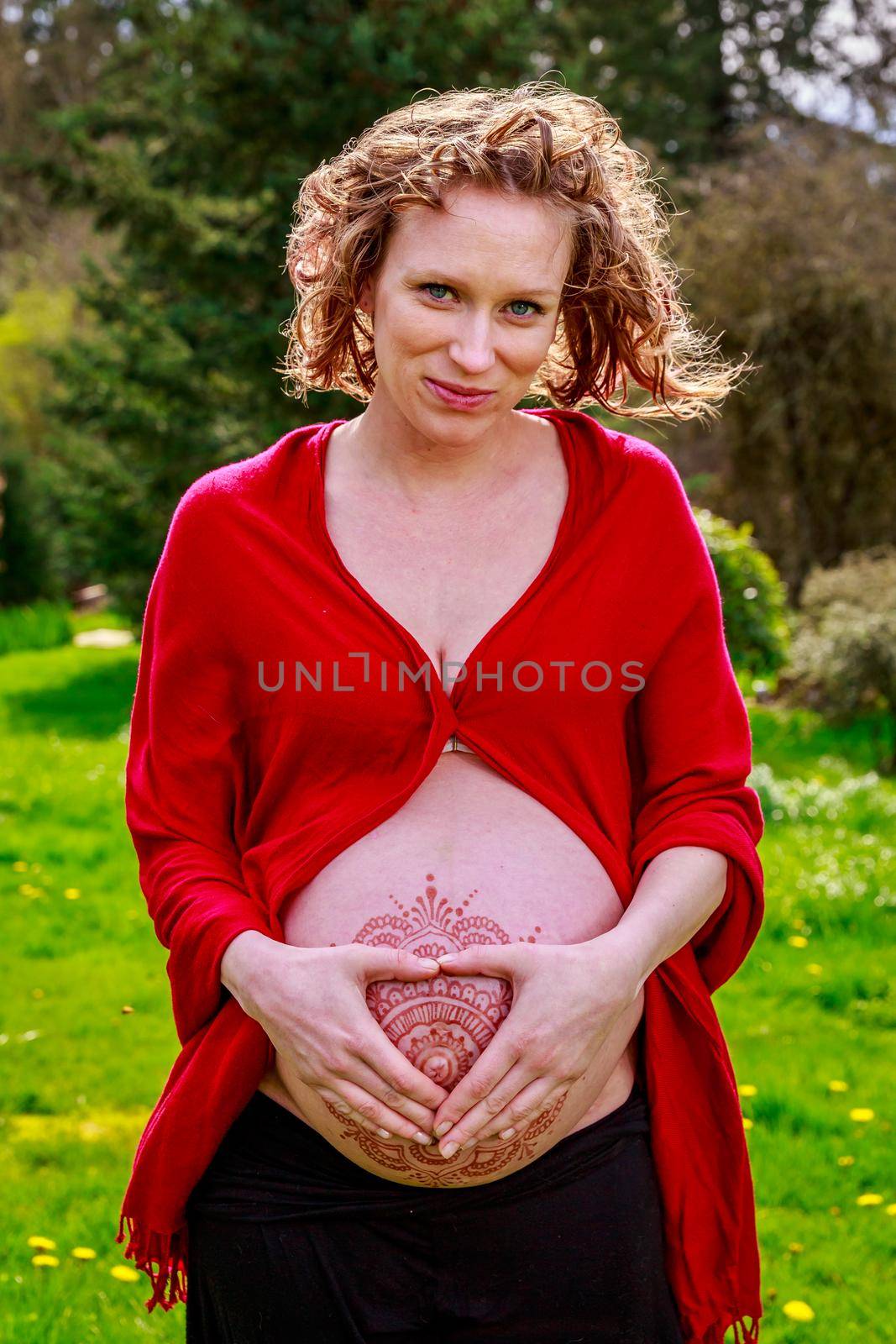 Young beautiful woman with pregnant belly showing.