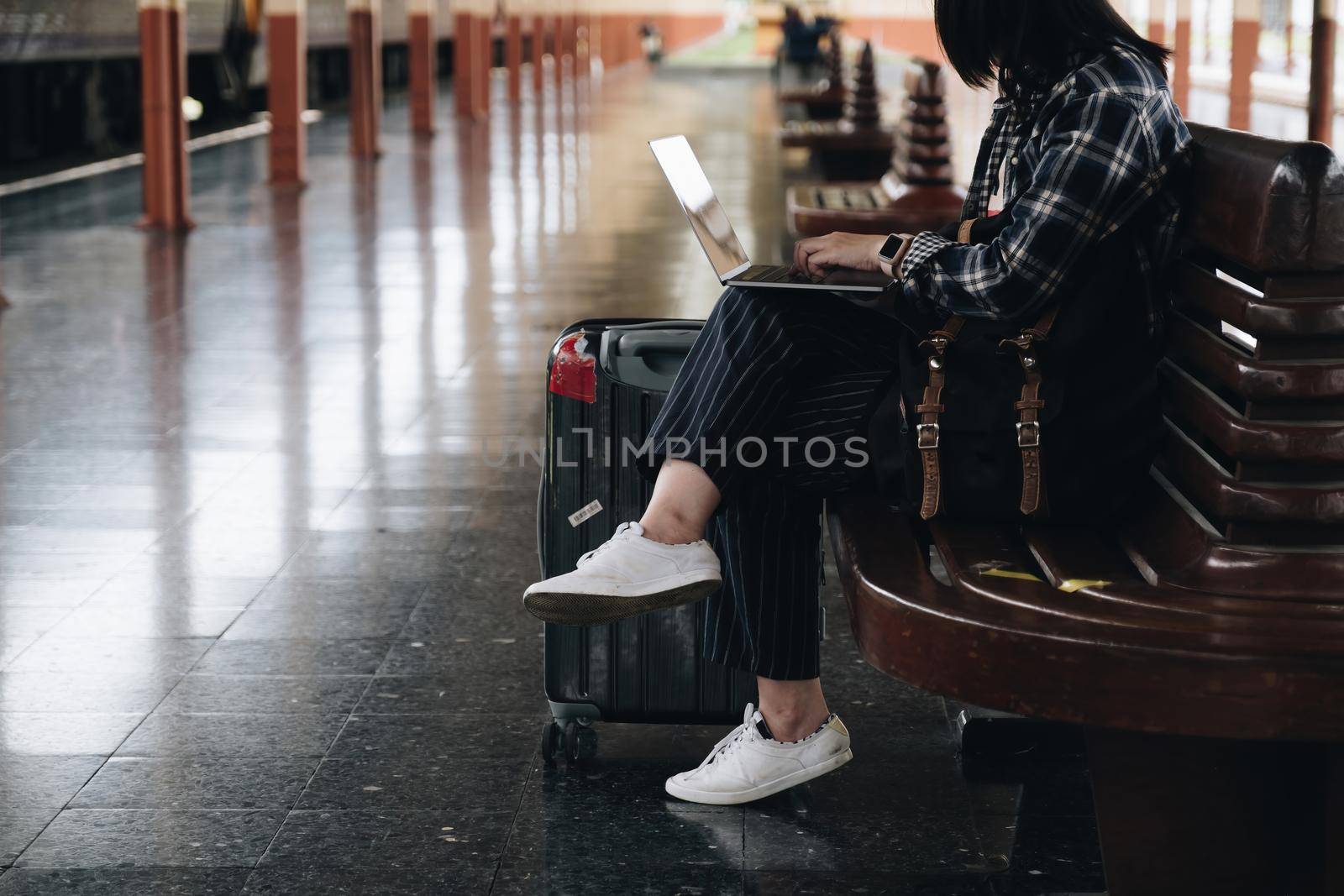 Image of Young freelance working at train station before travel. work and travel concept. by itchaznong