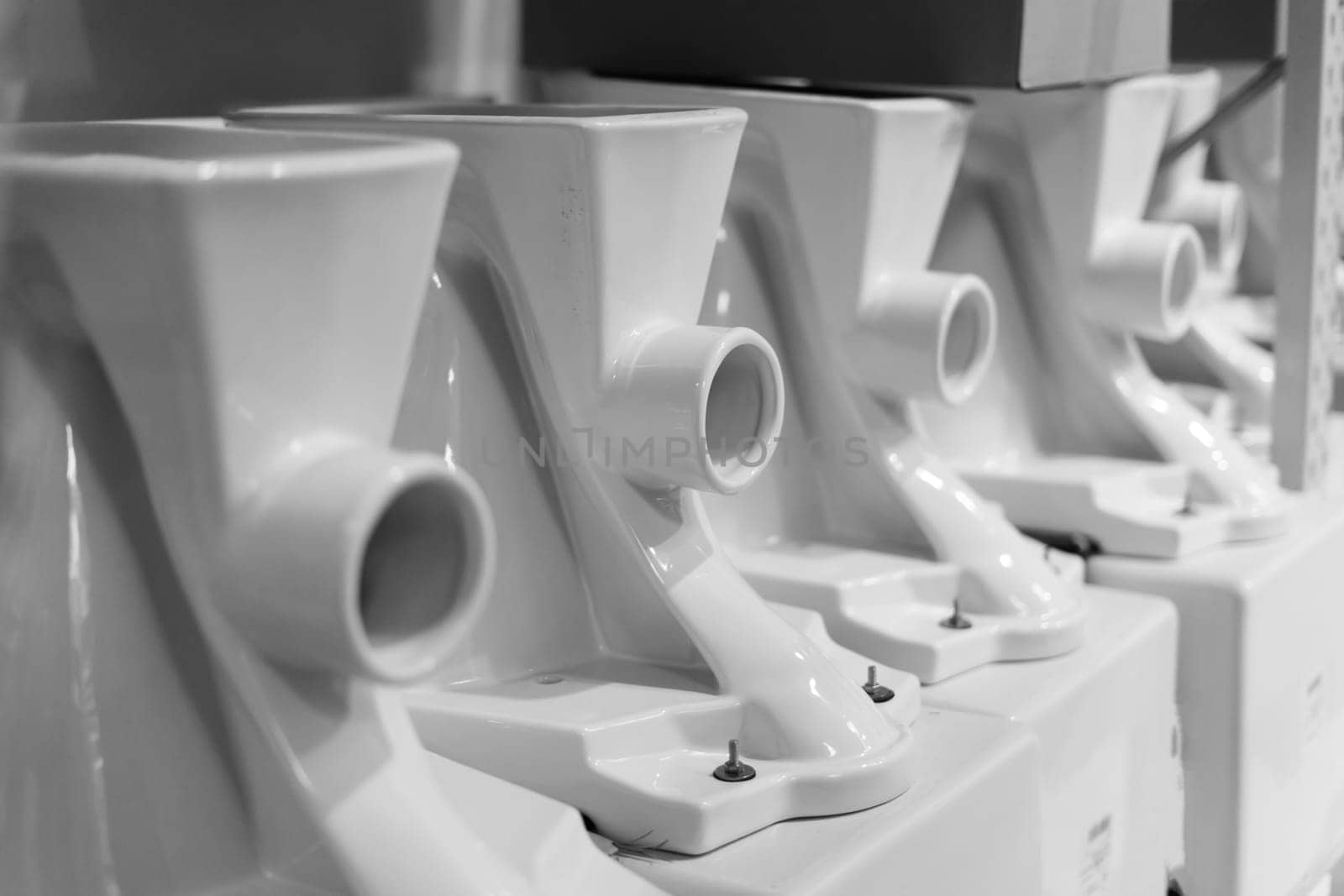 Lot of white toilets in hardware store, plumbing department by Zelenin