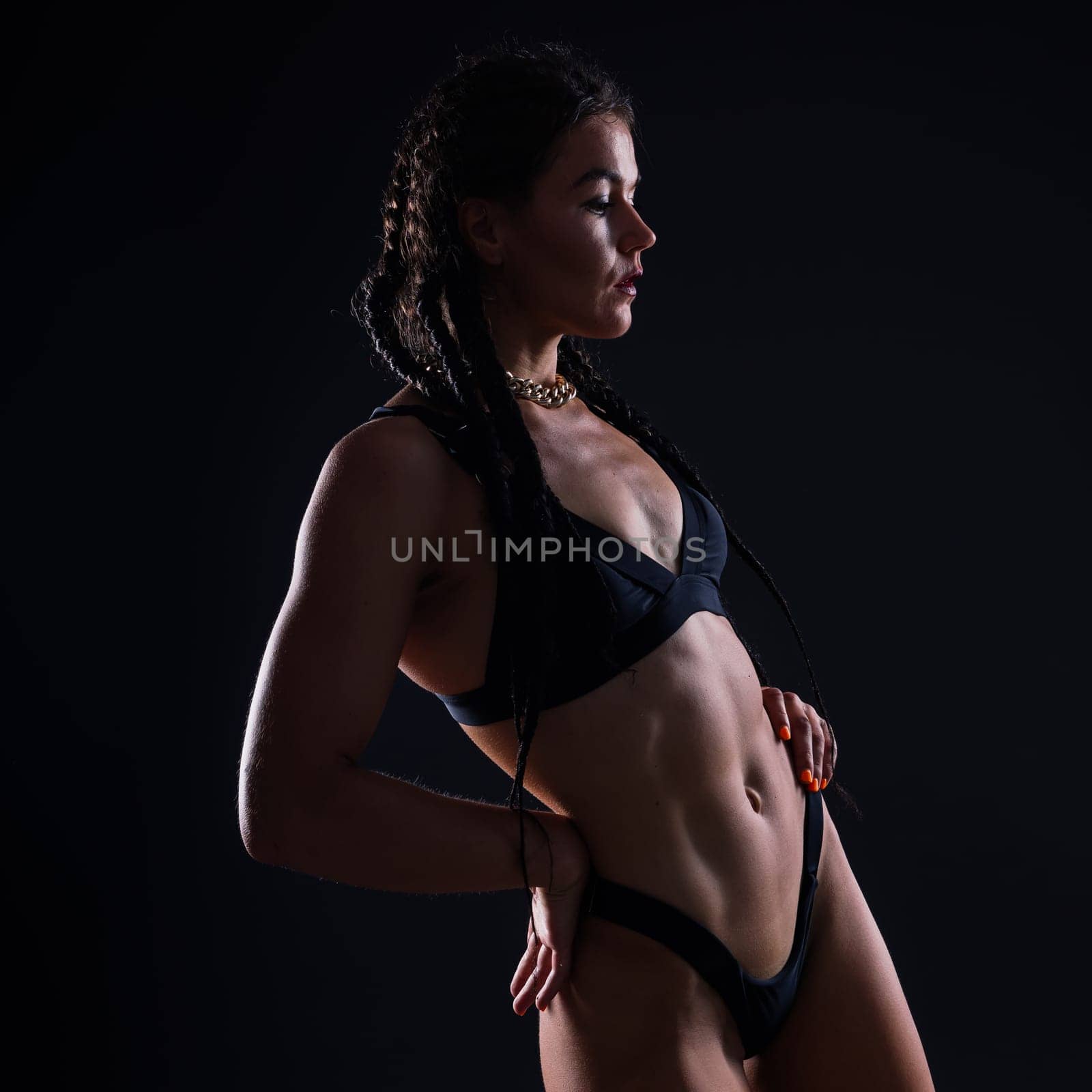 Perfect woman body on black background studio, sport muscles belly by Zelenin